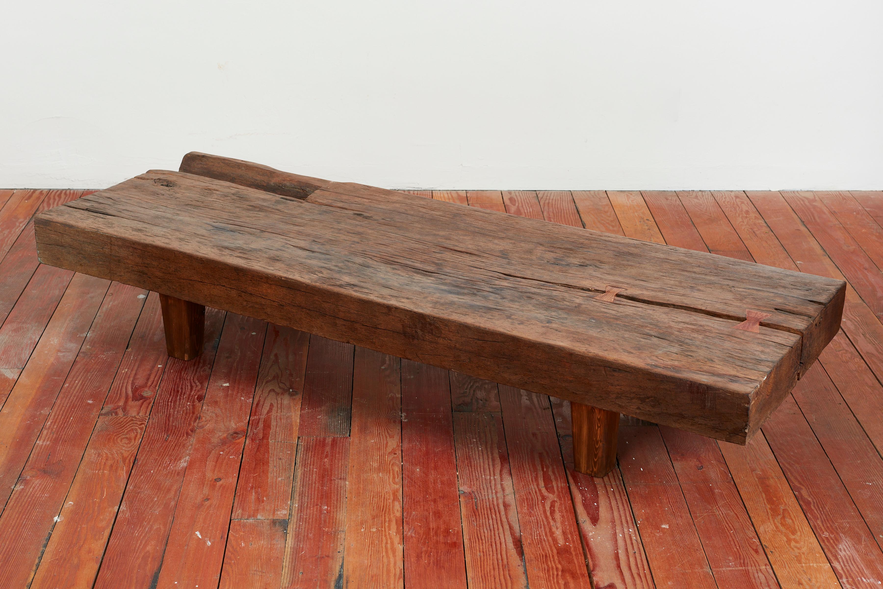Thick slab of teak wood bench or coffee table with incredible butterfly joints and character to the wood. 
Fabulous piece.