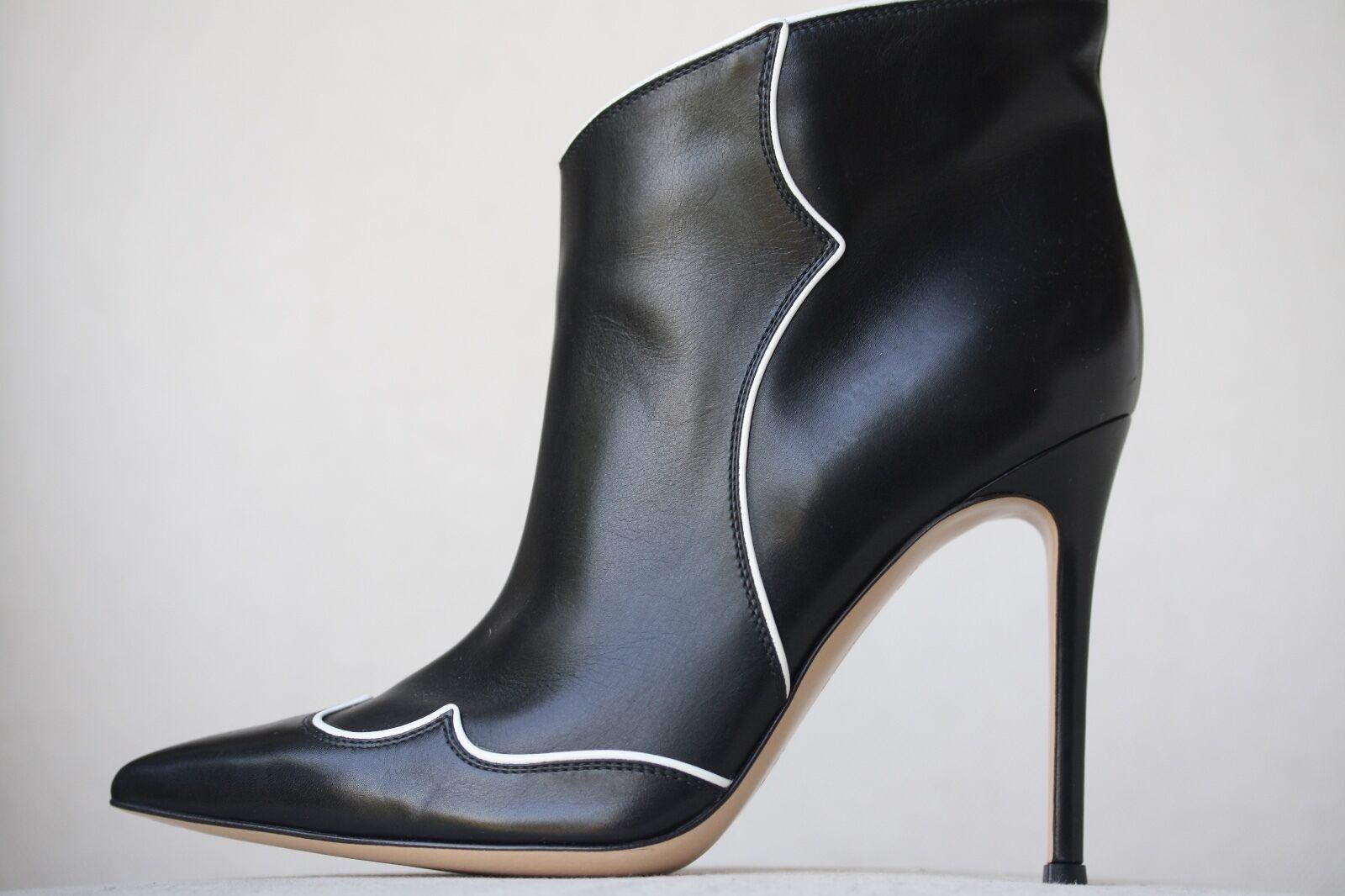 Piping gives Gianvito Rossi's boots a Western-inspired twist. This Italian-made pair is cut low at the front for a flattering effect. Heel measures approximately 105mm/ 4 inches. Black and white leather. Slip on. Fits true to size. Does not come