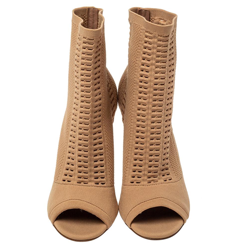 Add the Gianvito Rossi charm to your shoe collection with this pair of ankle boots. Crafted using knit fabric, the boots feature open toes and a comfortable, sock-like fit. They are lifted on 10.5 cm heels.

Includes: Original Dustbag, Price Tag,