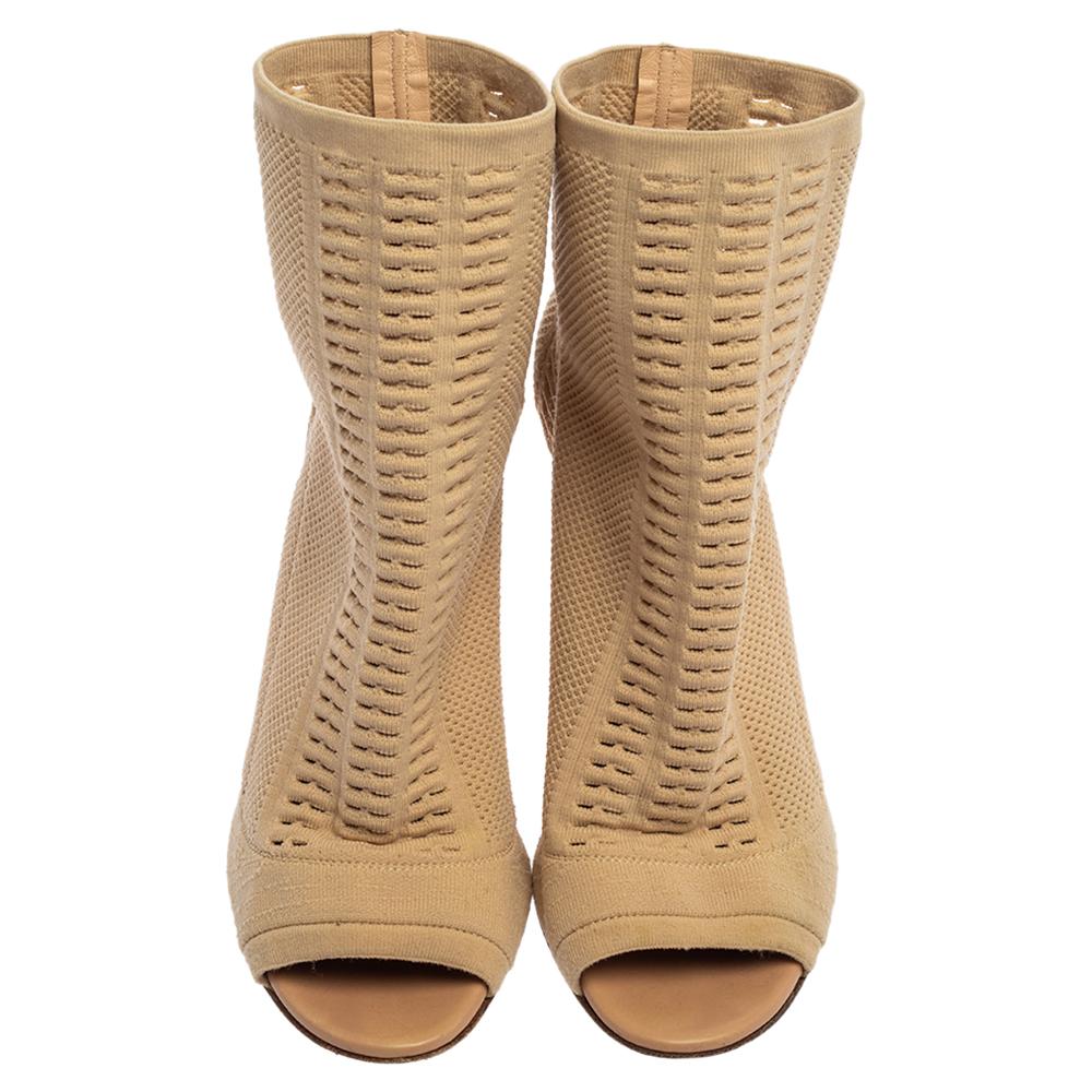 Boots come in all shapes, designs, and sizes but we're impressed the most by these ones from Gianvito Rossi! They are crafted from beige knit fabric and styled with peep toes and 11 cm stiletto heels. They are endowed with leather-lined comfortable