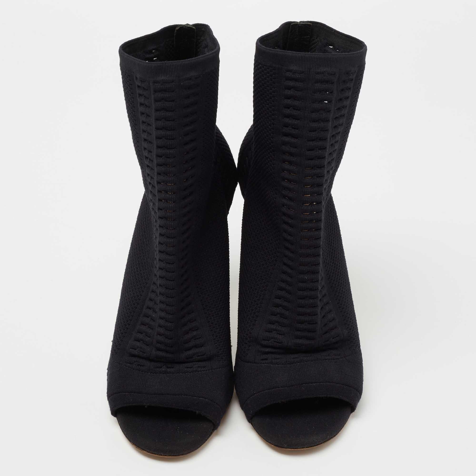 Add the Gianvito Rossi charm to your shoe collection with this pair of chic booties. Crafted using knit fabric, the black booties feature open toes and a comfortable, sock-like fit. They are lifted on 11 cm heels.

