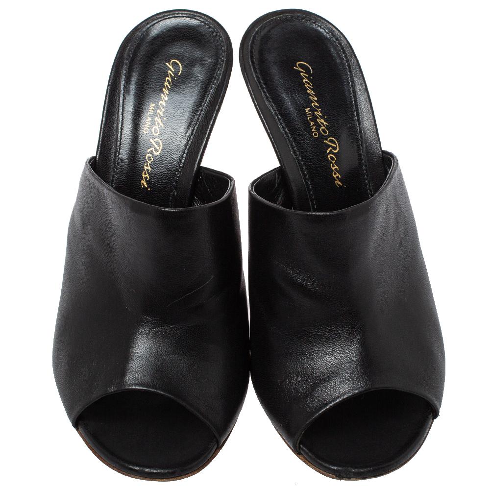 These Gianvito Rossi mules are effortlessly chic and stylish! Crafted from black leather, they feature open toes, a single vamp strap, and 9 cm heels. The insoles are lined with leather and carry the brand label.

Includes: Original Dustbag,