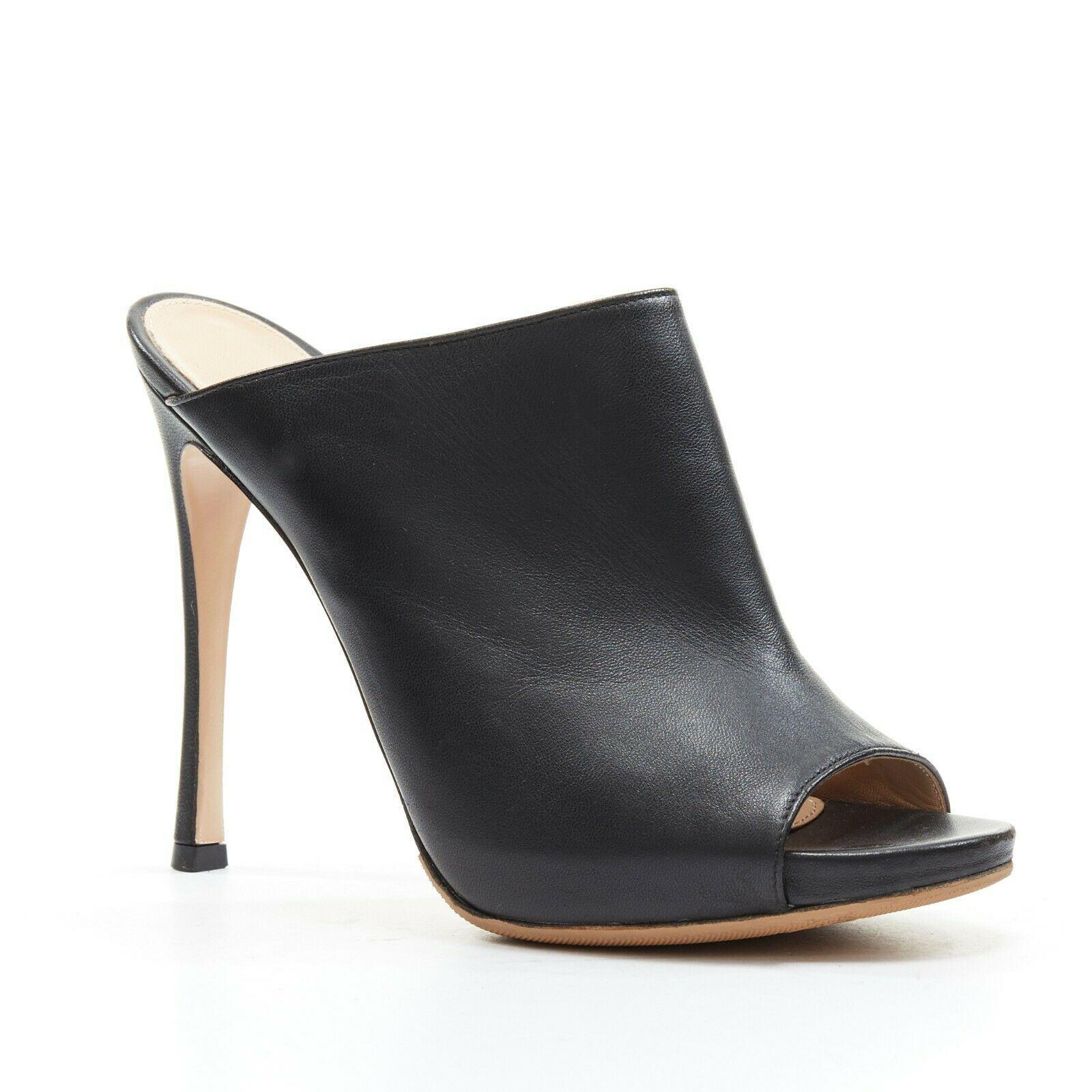 GIANVITO ROSSI black leather open toe high heel slip on mule EU37
GIANVITO ROSSI
Black leather upper. 
Open toe. 
Concealed platform. 
Tonal stitching. 
Slip on mule. 
Stiletto heel. 
Made in Italy.

CONDITION:
Very good, this item was pre-owned and