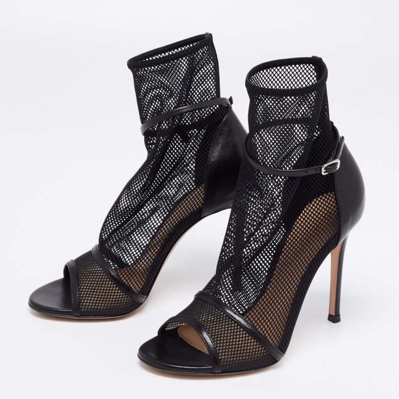 How classy are these booties from Gianvito Rossi! Made from black mesh and leather, these booties on elevated on slender heels and enhanced with open-toes, an ankle-length silhouette, and silver-tone hardware. These booties can be paired with your