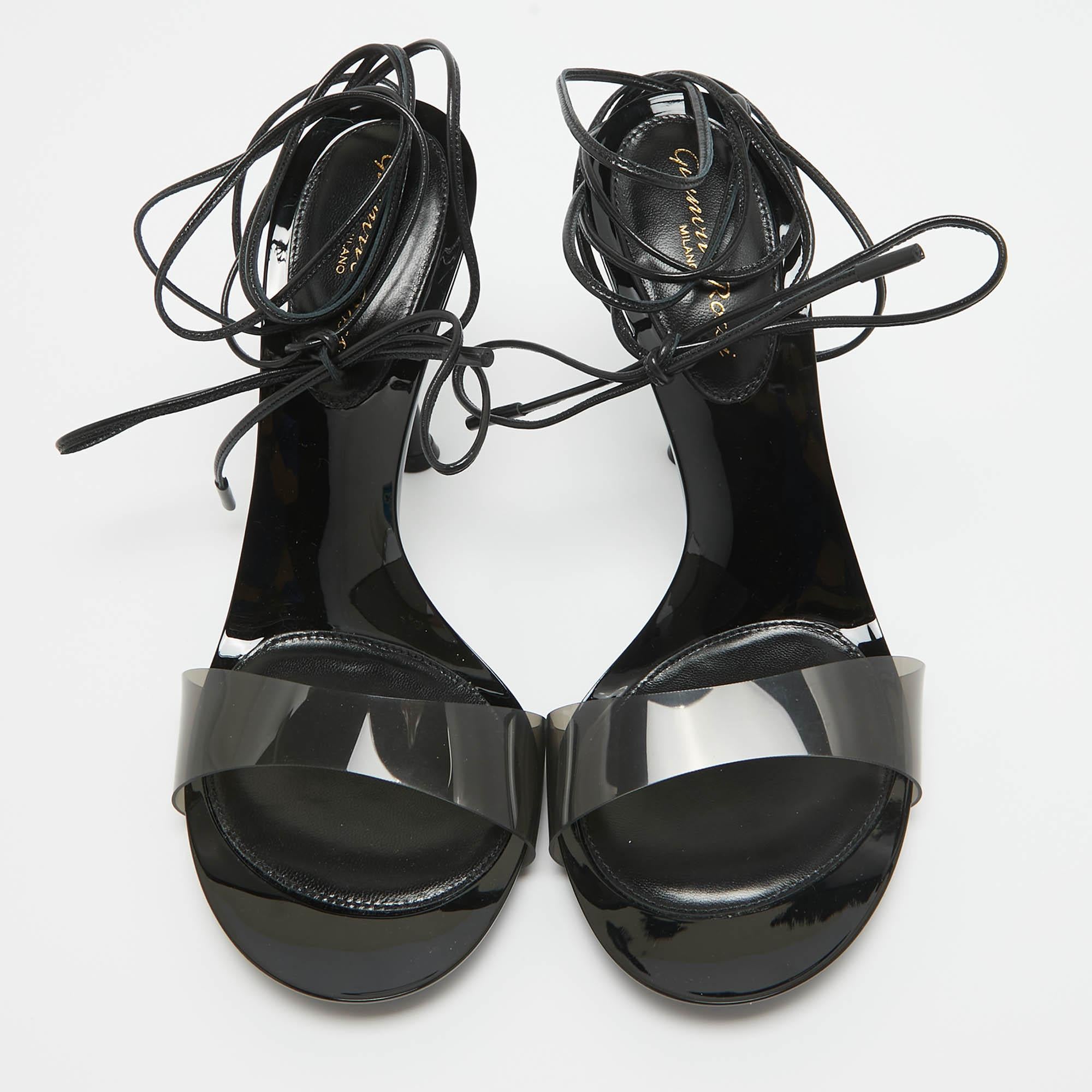 Indulge in luxury with Gianvito Rossi's Spice ankle tie Sandals. Crafted with meticulous attention to detail, these sandals boast a captivating blend of PVC and black leather, culminating in a sophisticated ankle tie design that exudes elegance and