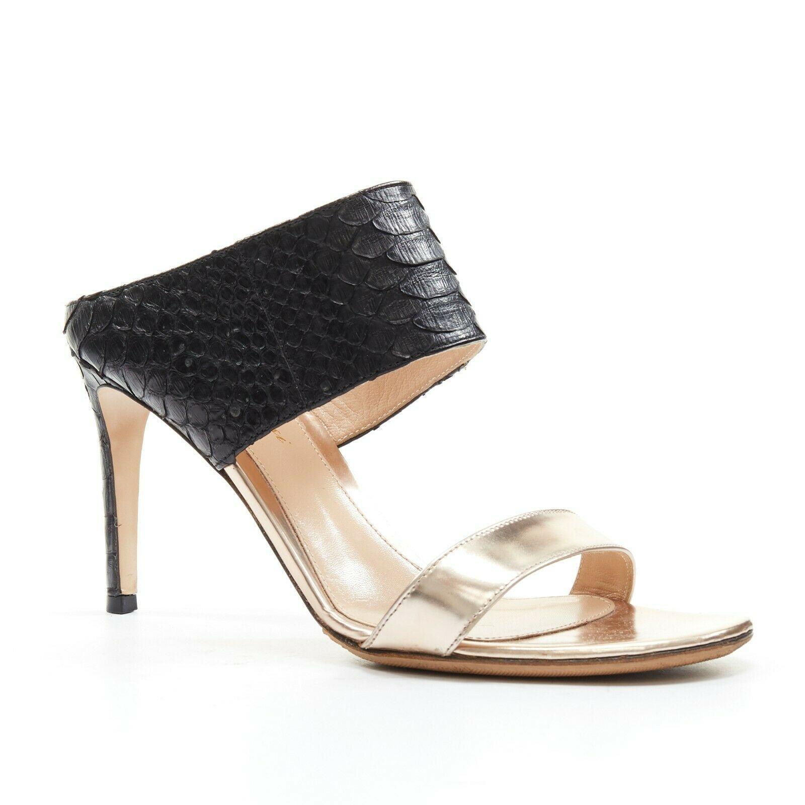 GIANVITO ROSSI black python metallic copper strap open toe mule heel EU37
GIANVITO ROSSI
Black scaled python leather upper. 
Metallic copper leather. 
Open toe. 
Tonal stitching. 
Slip on mule sandals. 
Stiletto heel. 
Made in