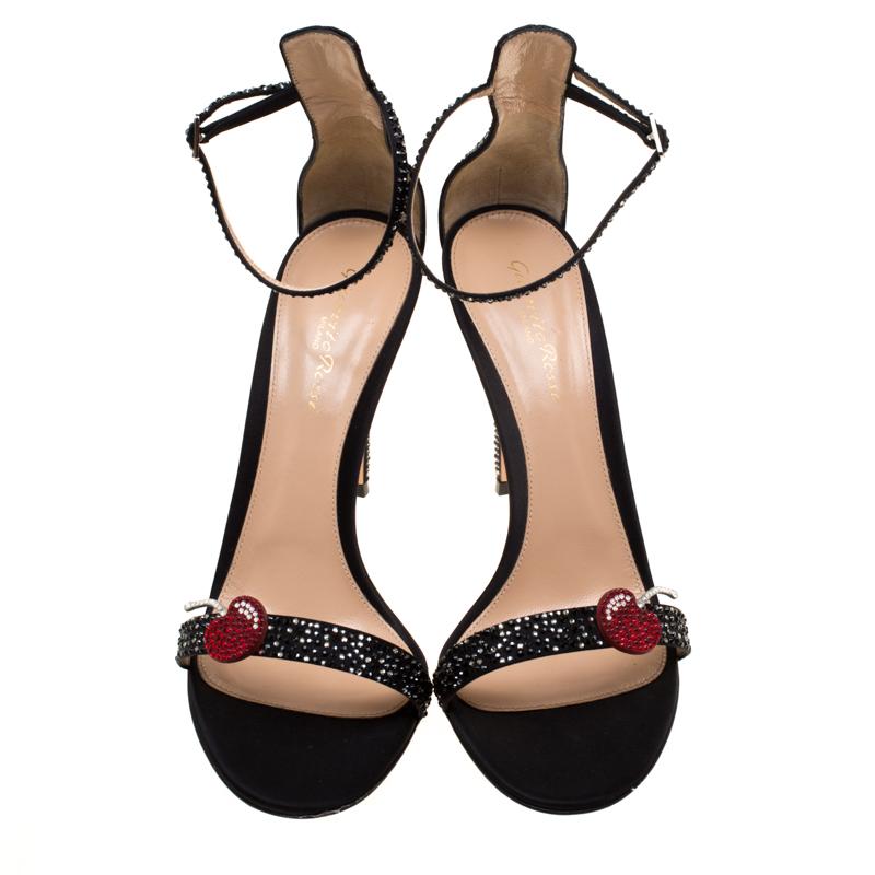 Pure elegance, these Portofino sandals from Gianvitto Rossi are all you need to make an impression! These black sandals have been crafted from satin in an open toe silhouette. They are embellished with crystals and a Cherry motif on the vamp straps