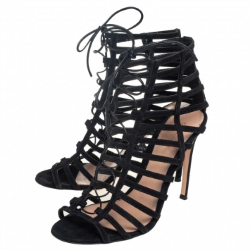 In a glorious design of black hue comes these sandals from Gianvito Rossi for you to waltz in glamour. The sandals feature a strappy caged design with laces, open toes, and are balanced on 11 cm heels to give you the right lift of poise.