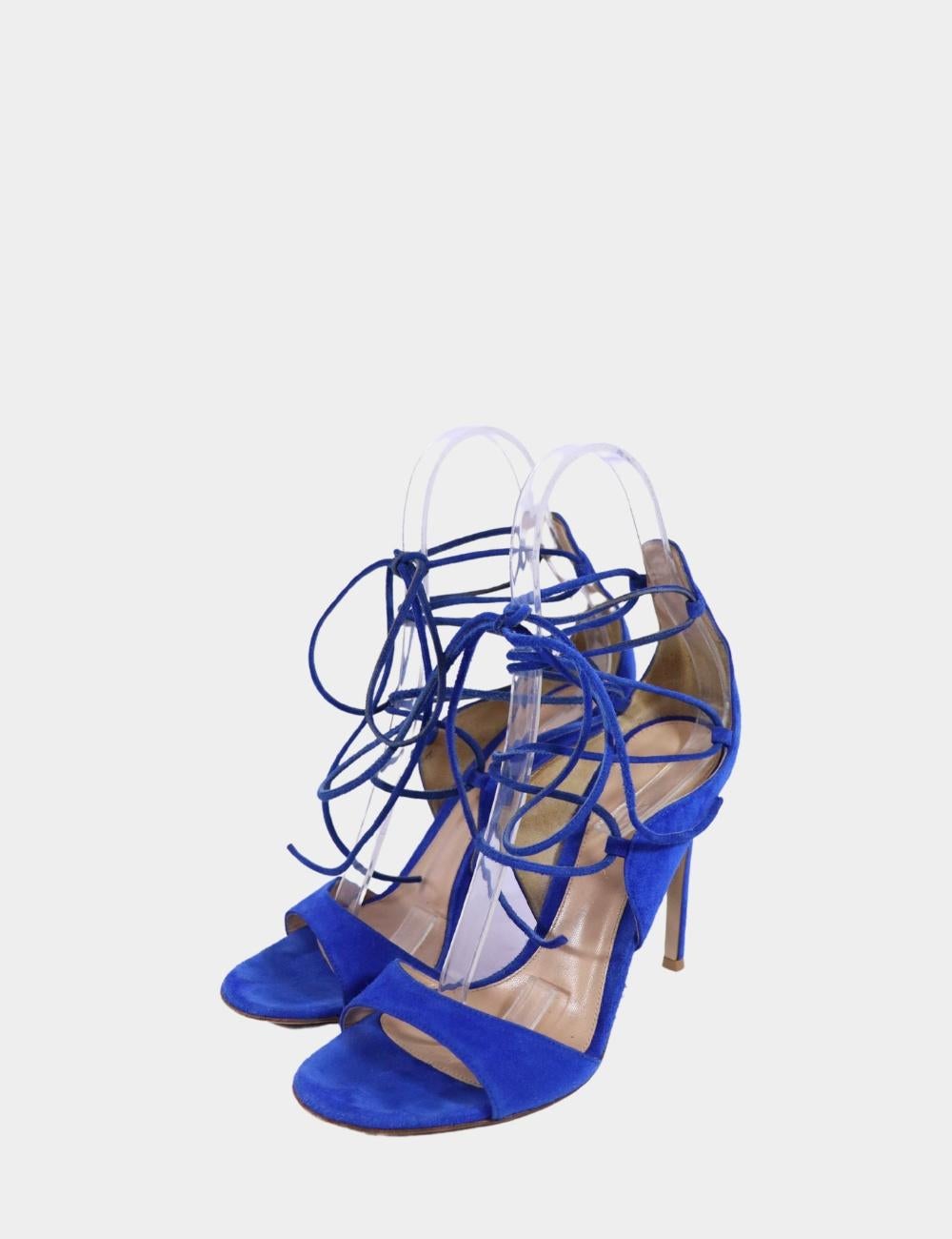 Make a bold entrance in these Gianvito Rossi cobalt blue lace-up heels, crafted in luxurious suede and designed with the brand’s signature Italian precision. Featuring an open toe, slender stiletto heel, and wrap-around ankle ties, these heels add