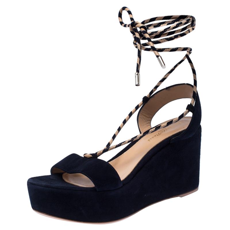 These sandals from Gianvito Rossi will lend a stylish edge to your ensemble. They feature suede straps, woven strings that wrap around the ankles and platform-wedge heels. You will feel fashionable and comfortable in this blue pair.

Includes: