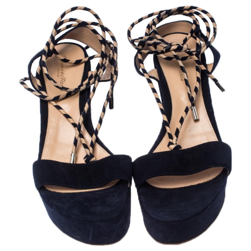 These sandals from Gianvito Rossi will lend a stylish edge to your ensemble. They feature suede straps, woven strings that wrap around the ankles and platform wedge heels. You will feel fashionable and comfortable in this blue pair.

Includes: Price