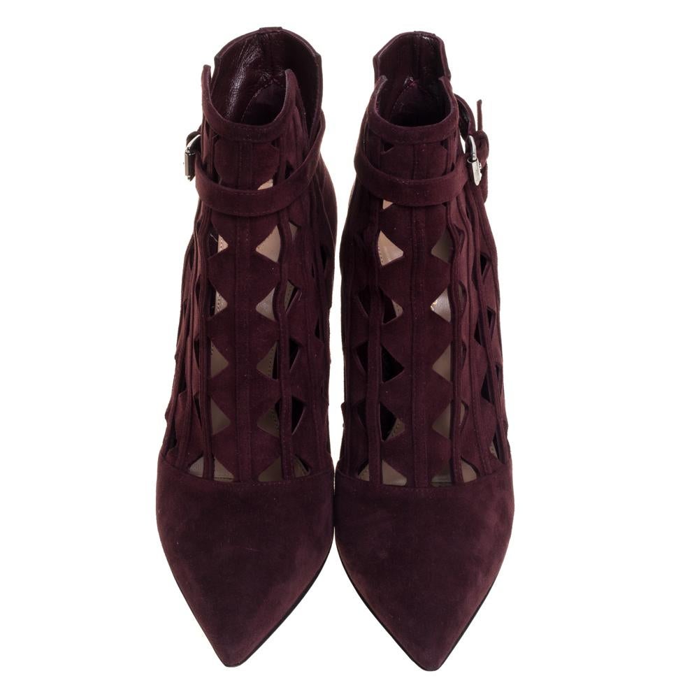 These burgundy ankle boots from Gianvito Rossi have been made to delight the tastes of fashion-forward ladies. They come in suede as pointed-toe boots with cutouts, buckle straps, 10.5 cm heels, and leather insoles.

Includes: Original Box, Original