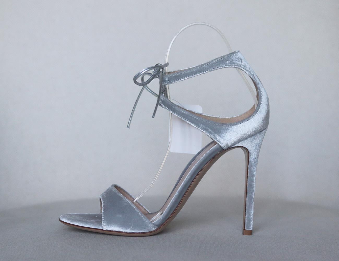 Gianvito Rossi's coveted 'Darcy' sandals are updated this season in silver, made from soft velvet, they're designed with a slim double strap that ties elegantly around the ankle. Heel measures approximately 105mm/ 4 inches. Silver velvet. Ties at