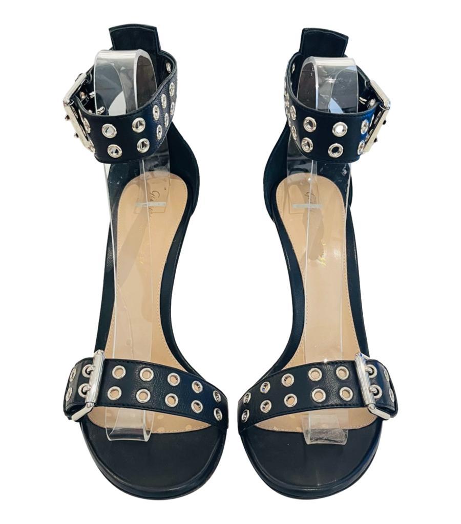 Gianvito Rossi Eyelet Embellished Leather Sandals

Black 'Kally' heels designed with open toe and buckled ankle strap embellished with eyelets.

Featuring silver hardware, stiletto heel and leather soles. Rrp £715

Size – 38

Condition – Very