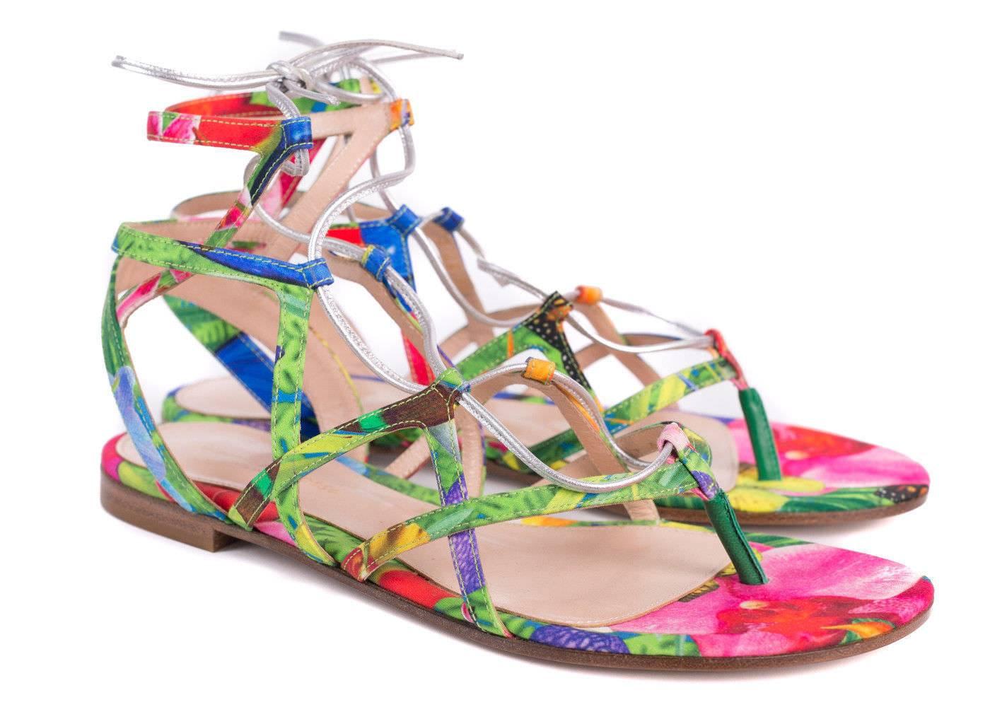 Parlay in the summer's haze with your Gianvitto Rossi floral sandals. These vibrant multicolored beauties feature a lightly futuristic metallic strap closure. You can pair these sandals with skinny white denim and a off-shoulder top for a sensual