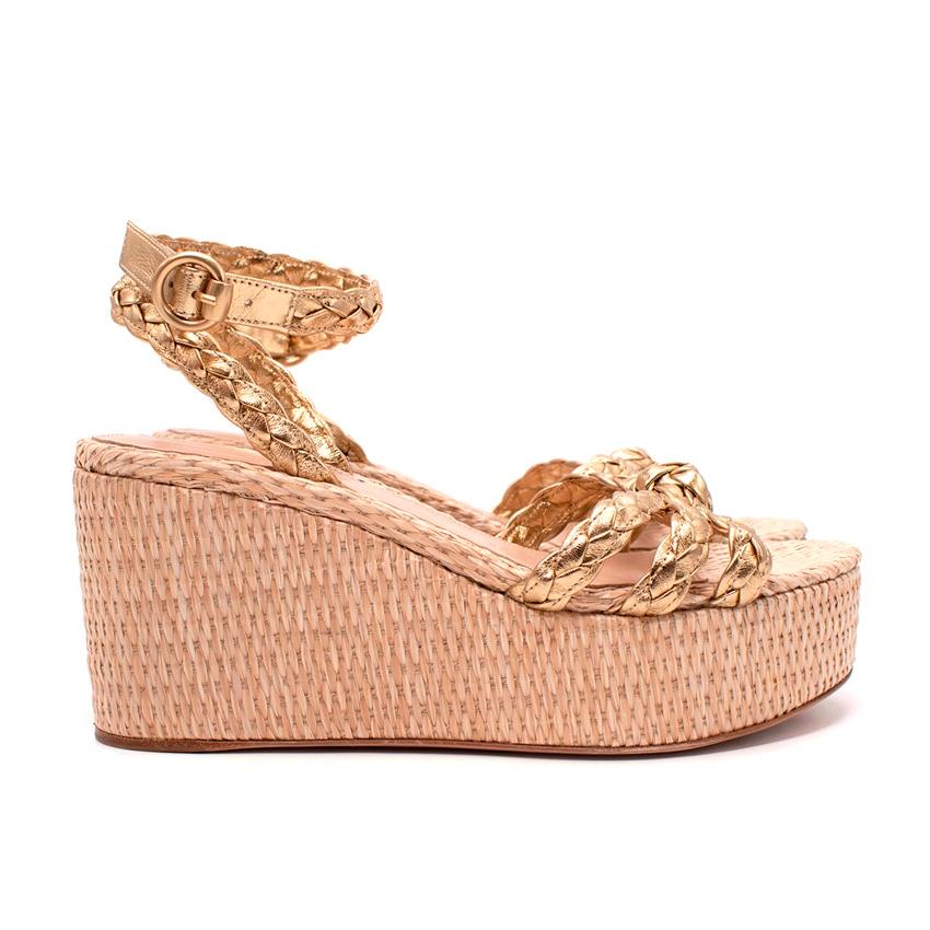 Gianvito Rossi Gold Braided Leather Wedge Sandals
 

 -Braided leather straps, knotted over the front of foot
 - Adjustable ankle strap with buckle
 - Set on raffia wrapped wedge sole 
 - Open toe, leather lined for comfort
 -Highlight the metallic
