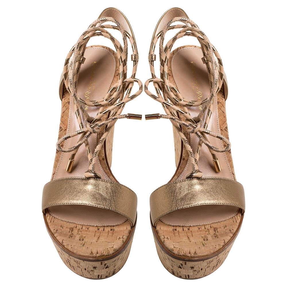 These sandals from Gianvito Rossi will lend a stylish edge to your ensemble. They feature leather straps, woven strings that wrap around the ankles, and platform wedge heels. You will feel fashionable and comfortable in this gold-hued