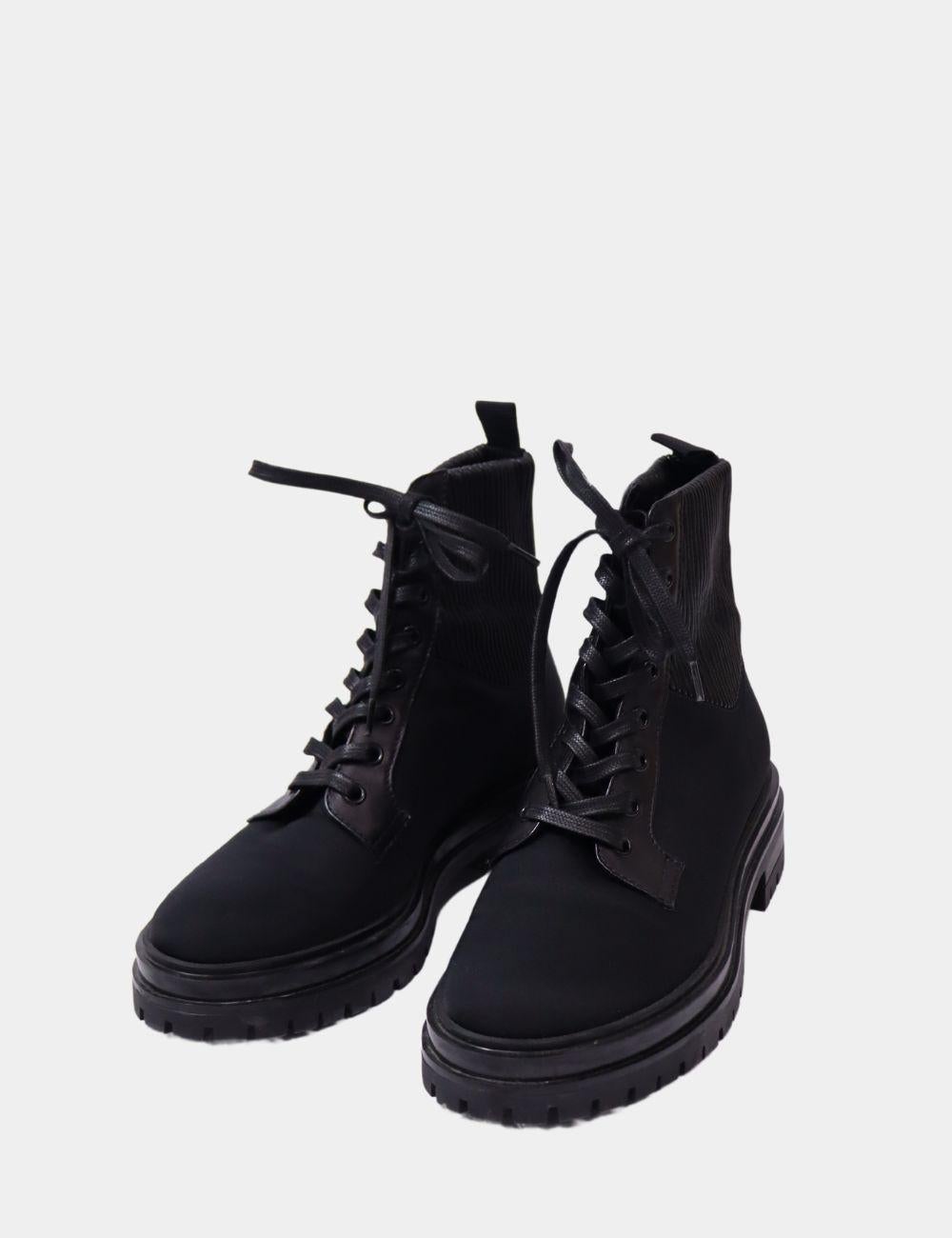 Tough meets luxe with these Gianvito Rossi Black Combat Boots. Crafted from smooth black leather and neoprene fabric, these lace-up ankle boots feature a chunky lug sole and sleek silhouette—perfect for modern urban style. Designed for both fashion