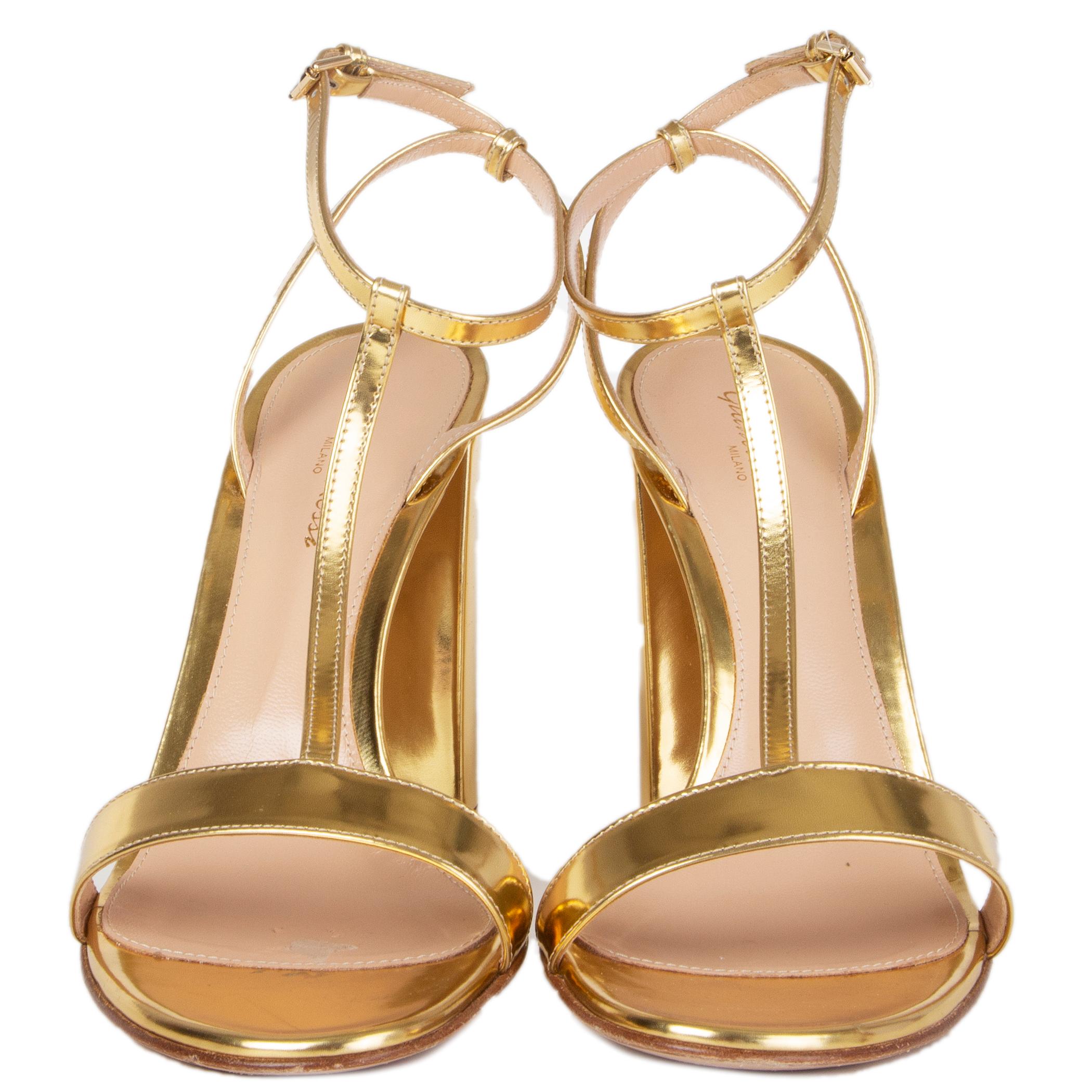 100% authentic Gianvito Rossi ankle-strap sandals in metallic gold-tone calfskin. Have been worn once with a faint scratch on the left heel and a mark on the inside sole of the right heel from a sticky insole. Overall condition is excellent.