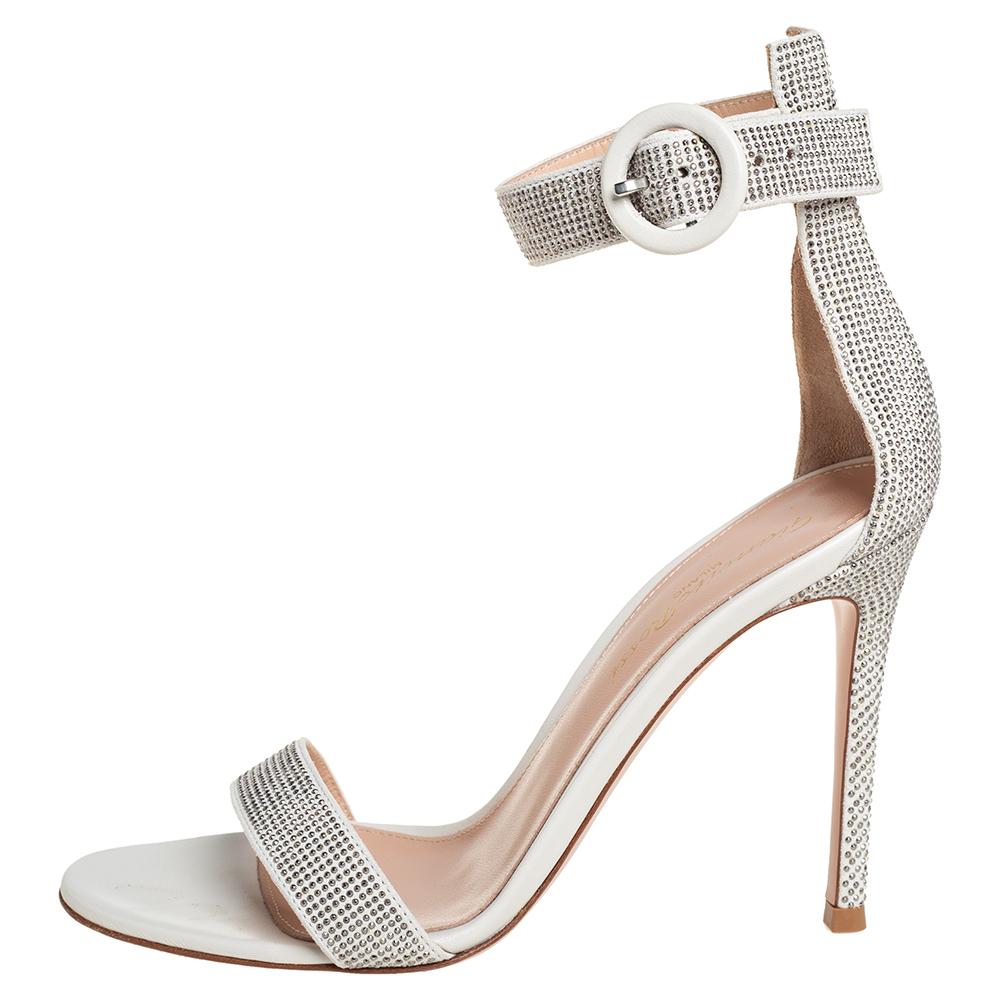 These Portofino sandals from Gianvitto Rossi are all you need to make an impression! These off-white sandals have been crafted from embellished suede in an open-toe silhouette. They flaunt single vamps straps and come equipped with buckled ankle