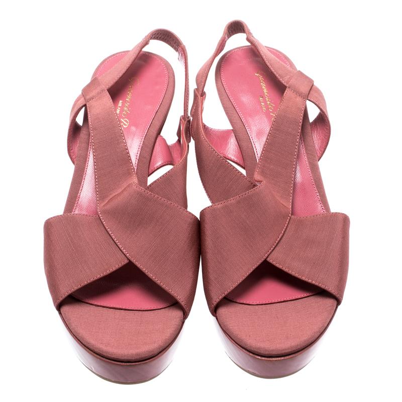 Charm your way with these fabulous sandals from Gianvito Rossi. Beautifully crafted, they carry straps made of pink canvas, insoles lined to provide comfort and 7 cm matching wedges to give you confidence in every walk.

Includes: The Luxury Closet