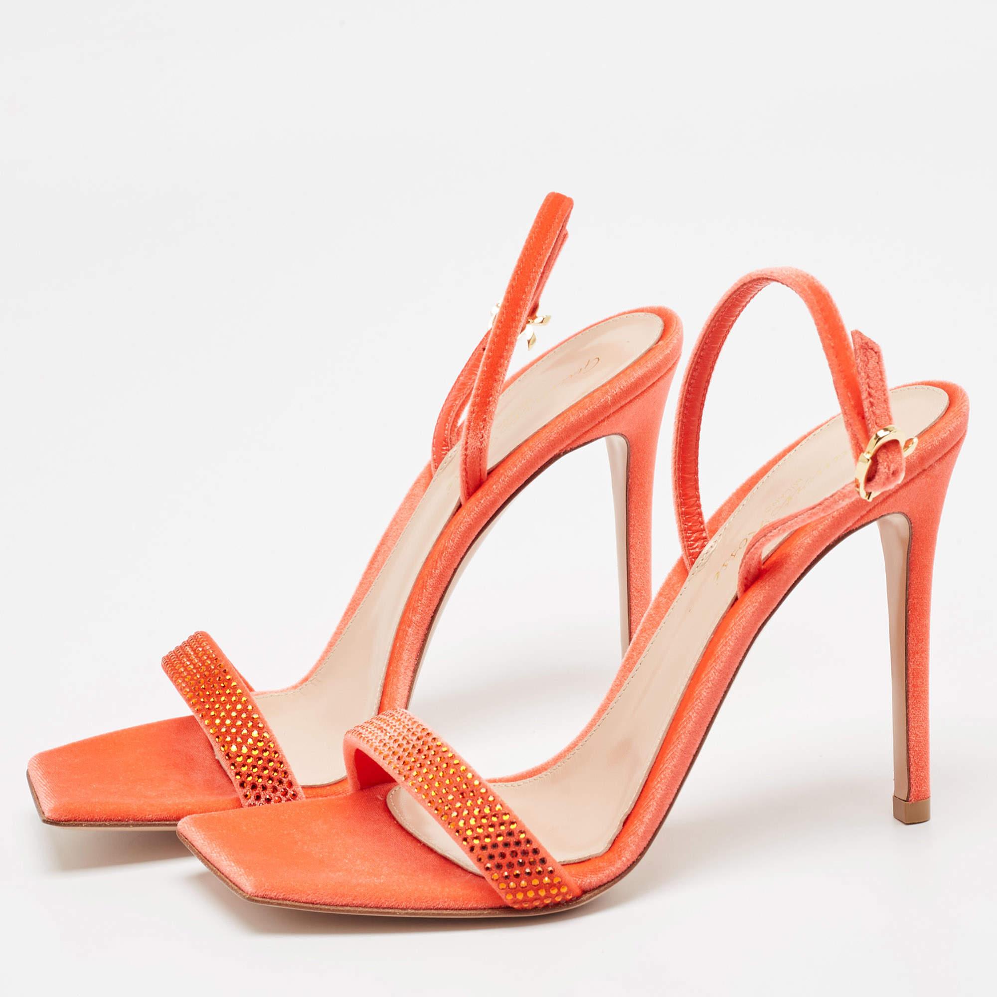 In poppy red leather the Gianvito Rossi sandals exude confident charm. Delicate straps gracefully embrace the foot while a sturdy heel provides stability and style. With impeccable craftsmanship and timeless design these sandals effortlessly command