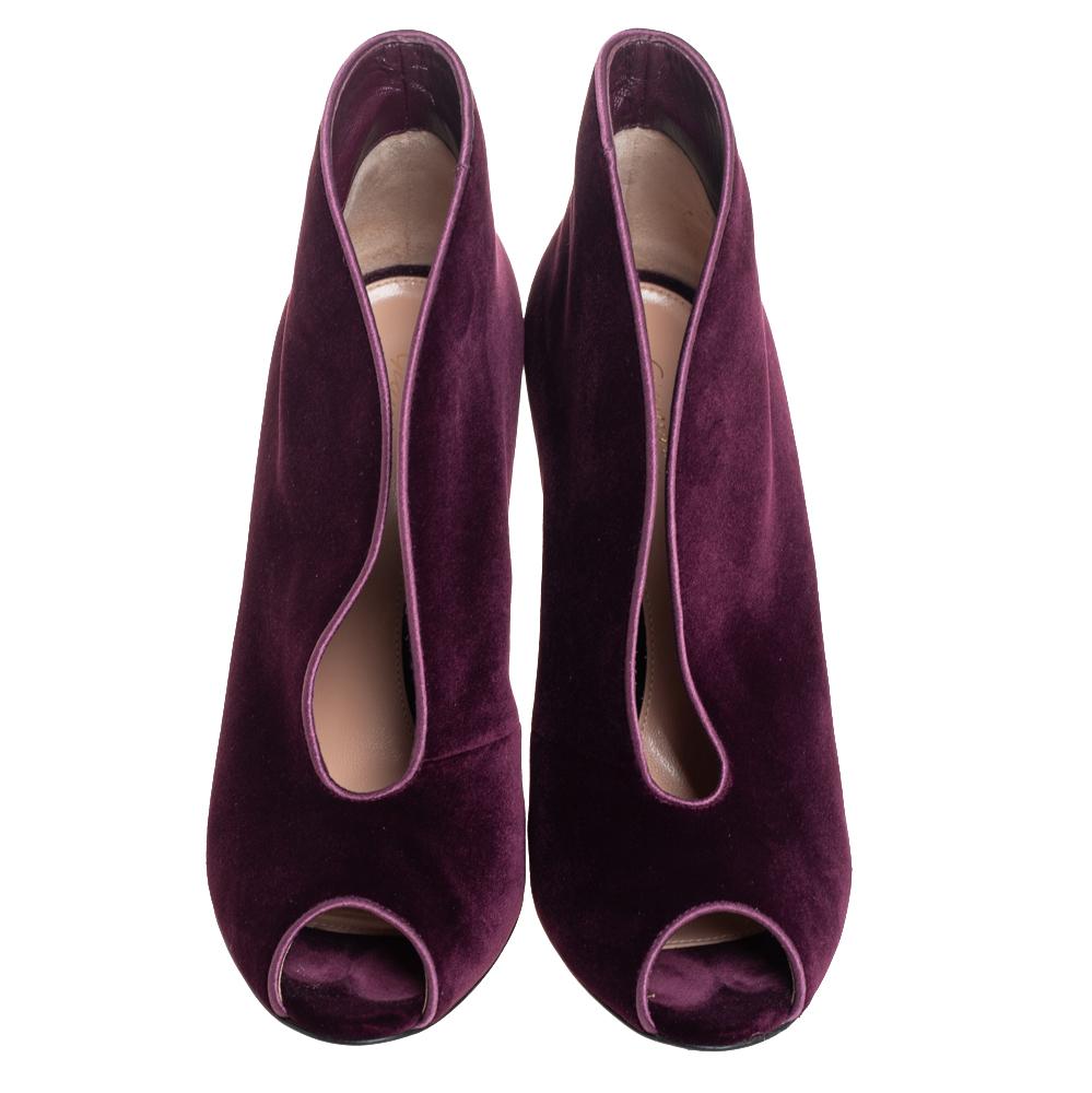 These glamorous booties from Gianvito Rossi are chic and worth admiring! They have been crafted from purple velvet and styled with peep-toes and curved open vamps. They come equipped with comfortable leather-lined insoles and stand tall on stiletto