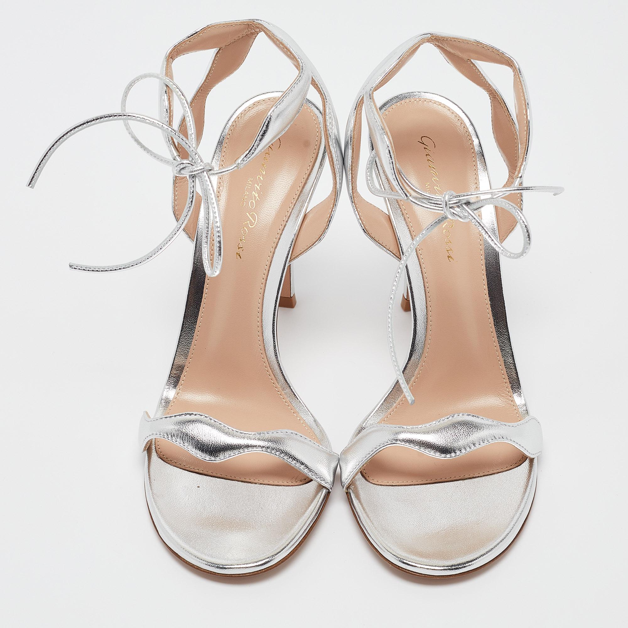 Crafted by Gianvito Rossi, these Wavy sandals redefine chic. The metallic hue shimmers effortlessly, while the wavy design adds a touch of whimsy. The ankle tie detail exudes charm and ensures a customizable fit. Perfect for adding a dash of glamour