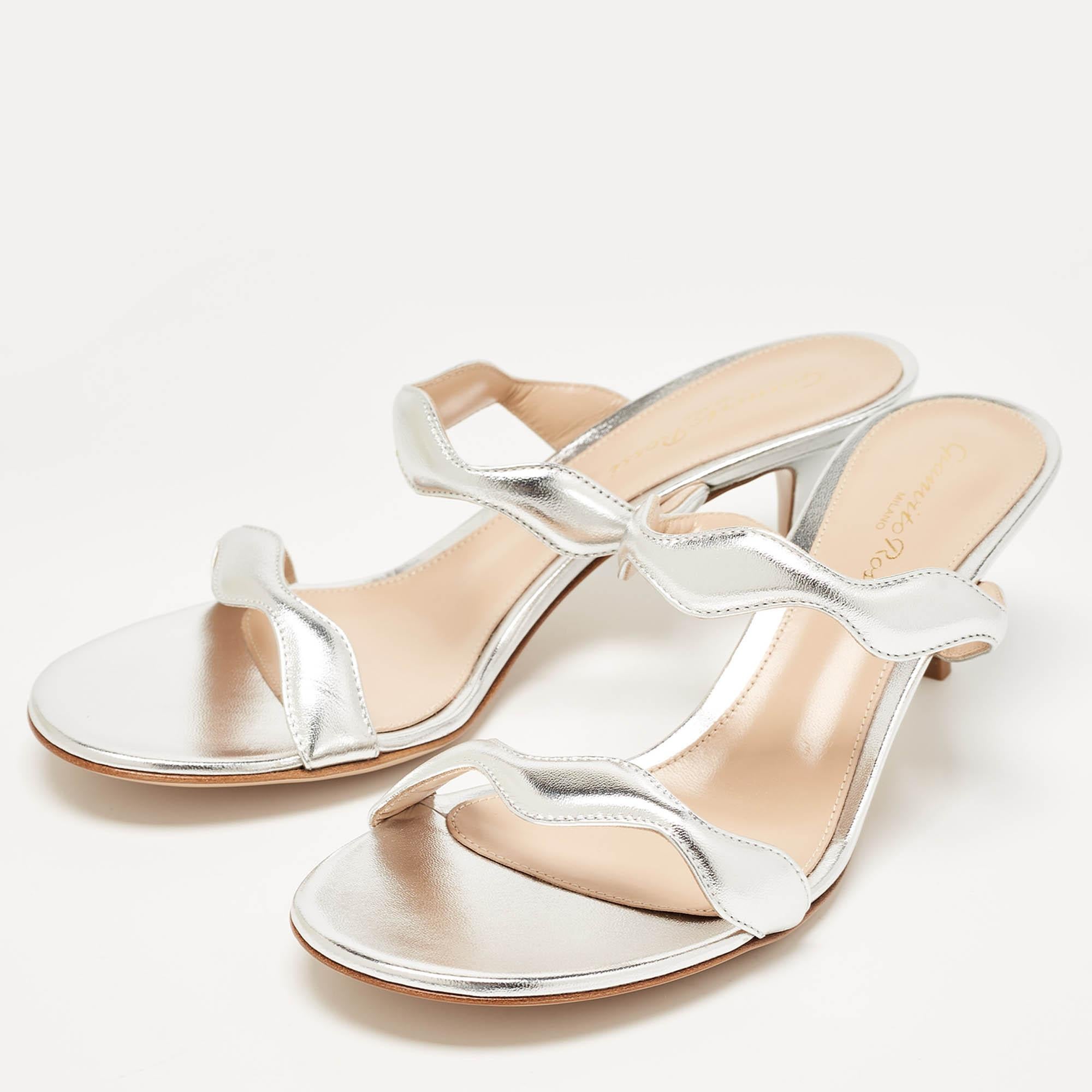Crafted by Gianvito Rossi these Wavy sandals redefine chic. The silver hue shimmers effortlessly while the wavy design adds a touch of whimsy. The ankle tie detail exudes charm and ensures a comfortable fit. Perfect for adding a dash of glamour to