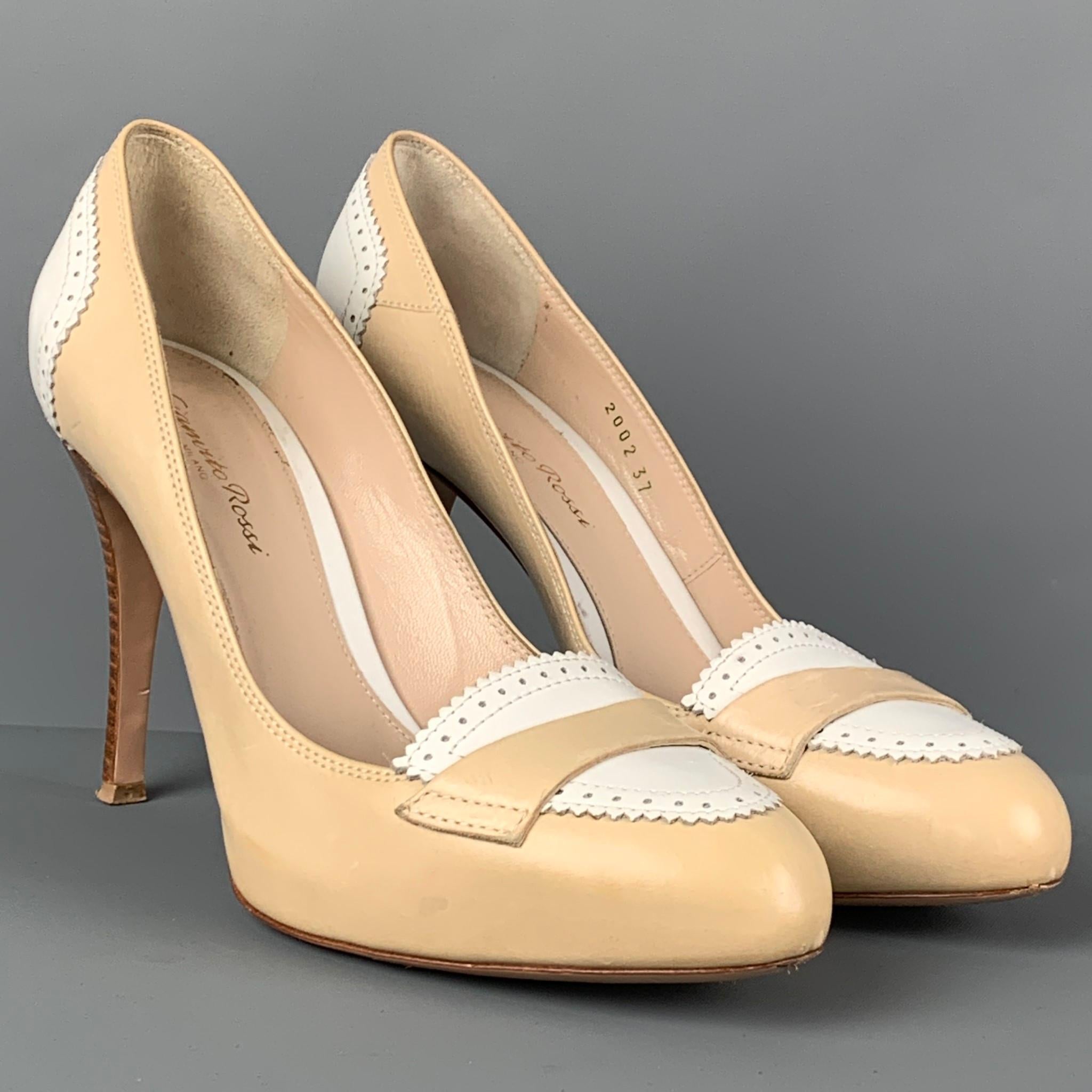 GIANVITO ROSSI pumps comes in a beige & cream perforated leather featuring a front strap detail and a stiletto heel. Made in Italy. 

Very Good Pre-Owned Condition.
Marked: 37
Original Retail Price: $750.00

Measurements:

Heel: 4 in. 