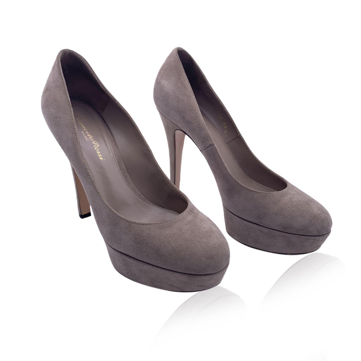 Classic Gianvito Rossi closed toe pumps. Crafted in taupe suede. They feature a round toe, slip on design, platform and a slim covered heel. Leather insole and outsole. Heels Height: 25 inches - 12.6 cm. Platform height: 1.2 inches - 3 cm Made in