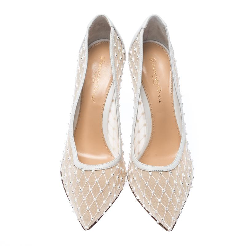 Raise the style bar wherever you go with this pair of Gianvito Rossi pumps. Made of lace and leather, they are designed with pointed toes, stiletto heels and embellishment of crystals. They will give you the perfect amount of fashion and