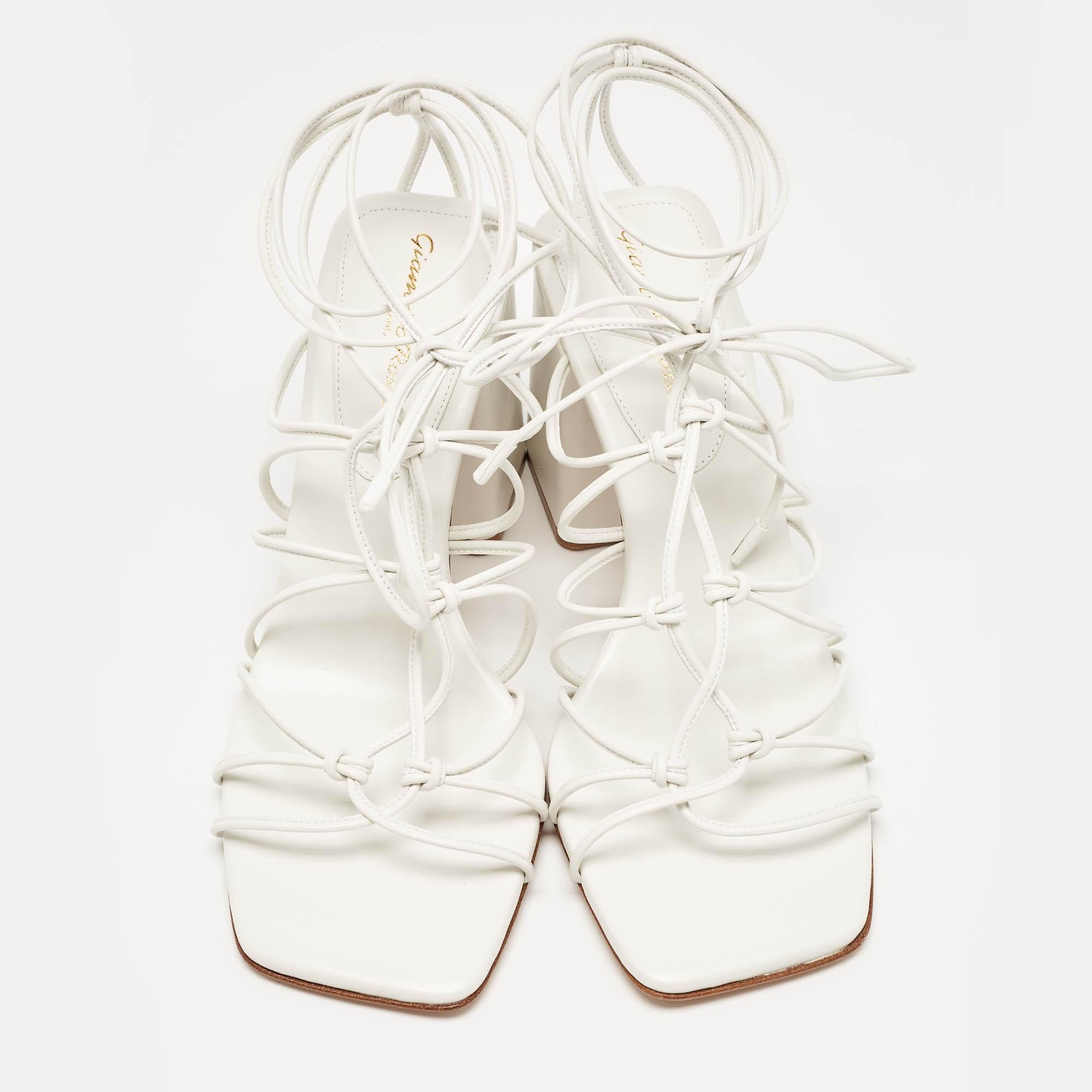 In classy white leather, the Gianvito Rossi Minas sandals exude confident charm. Delicate straps gracefully embrace the foot, while a sturdy heel provides stability and style. With impeccable craftsmanship and timeless design, these sandals
