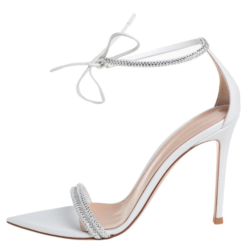 Delicate straps studded with crystals are laid over the toes and at the ankles to form this stunning Montecarlo design by Gianvito Rossi. Dreamy in white, the beauties are complemented with pointed toe beds and 11 cm high heels.

Includes: Original