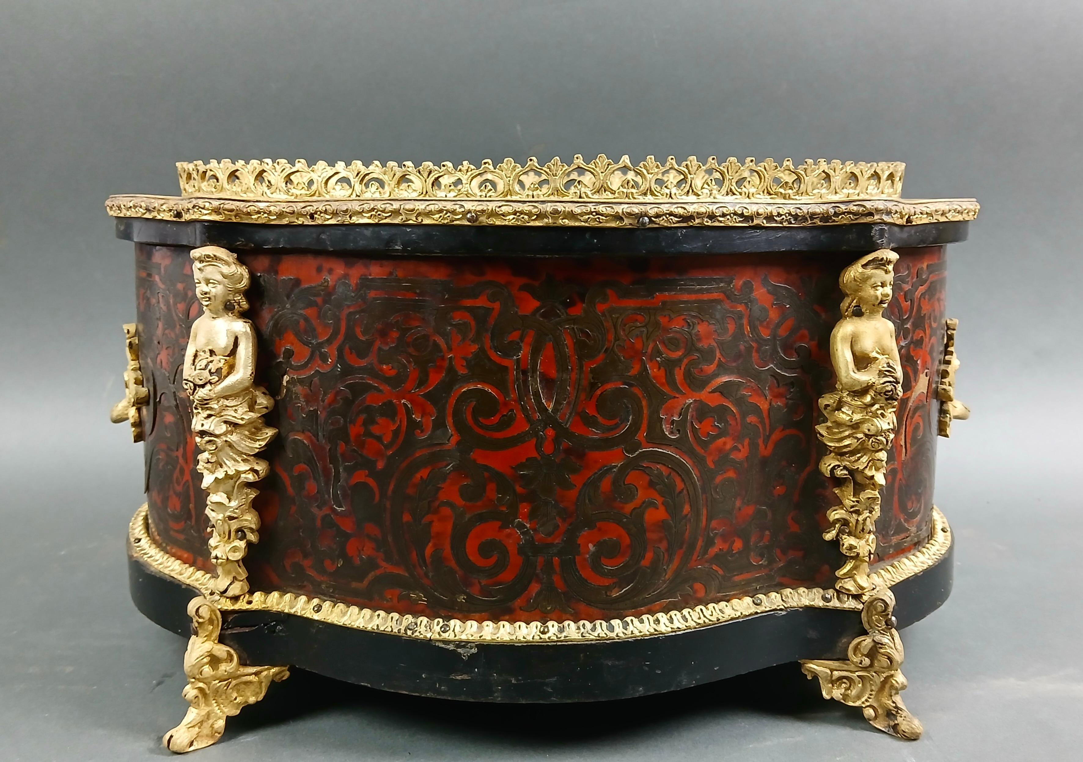 Beautiful Napoleon III-era giardiniera entirely encrusted in Boulle marqueterie and richly decorated with gilt bronze friezes. 
Sold as found, some lack visible in photos.

Measurements
H cm 21
L cm 37 
D cm 28