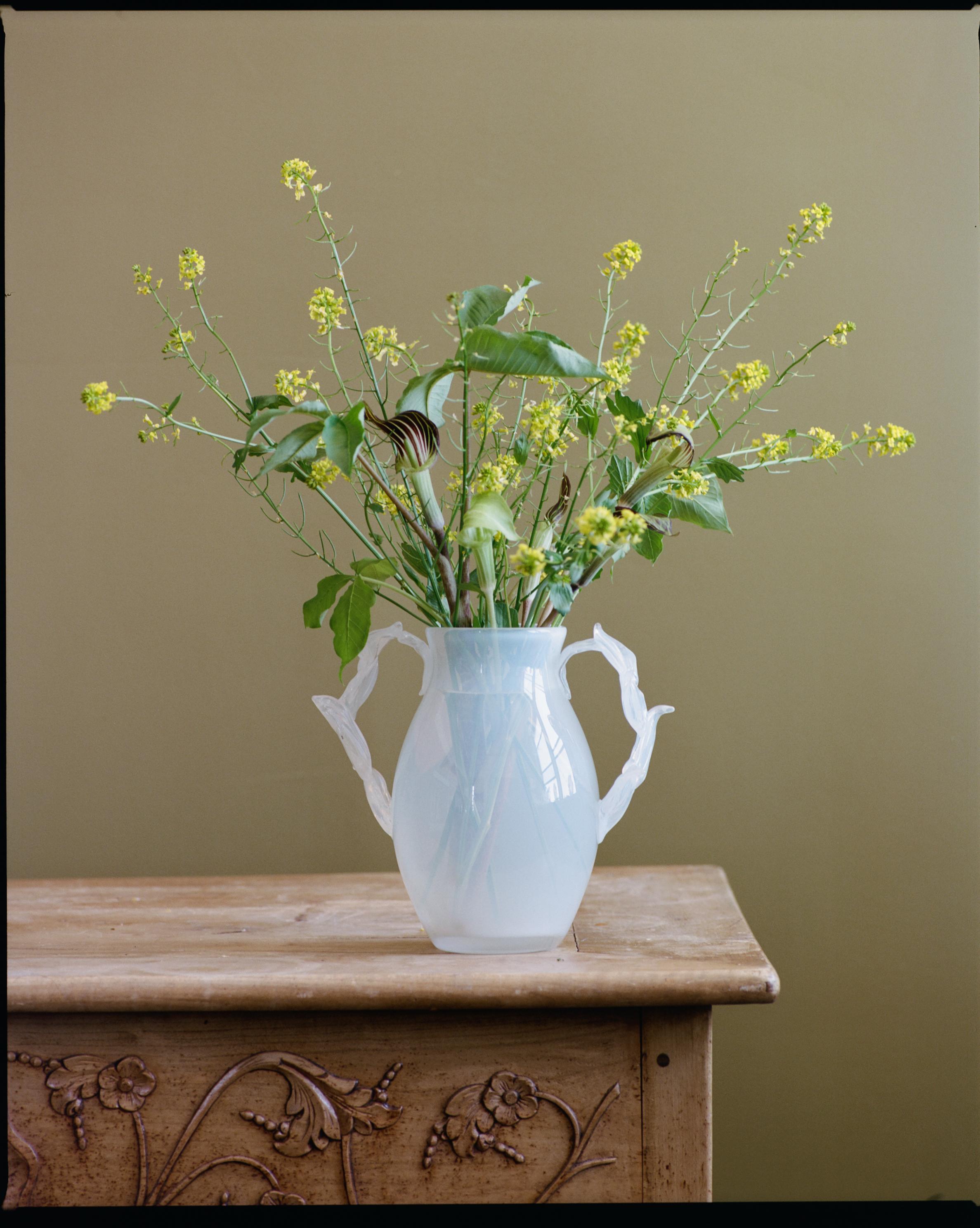 Hand blown soda lime glass vase with sculpted floral handles in alabaster white.  Part of our Giardino series, made in New York City.

Giardino Segreto’ or the ‘Secret Garden’ is a series of limited edition objects  that explore the poetic tension