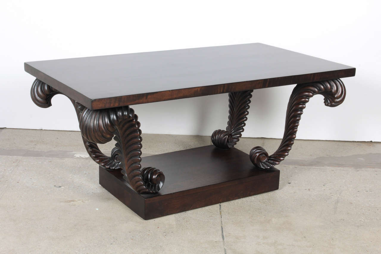 Art Deco influenced walnut coffee table with carved plume supports by T.H. Robsjohn Gibbings for Widdicomb. Table has been restored in a custom dark brown stain.