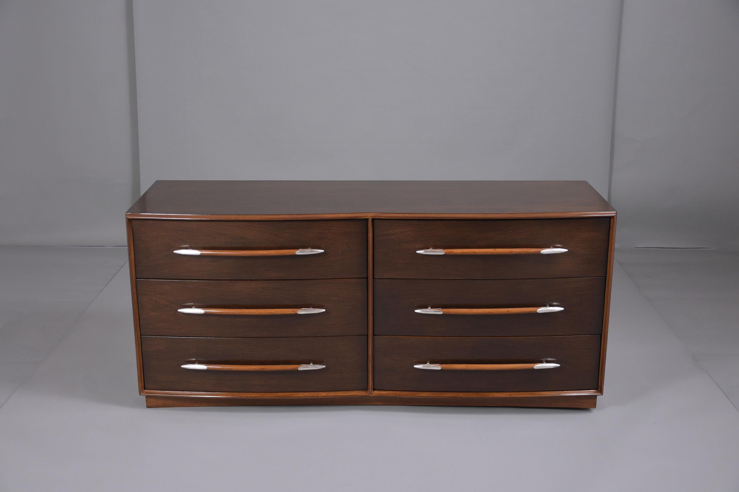 This T.H. Robs John Gibbings Widdicomb dresser has been newly stained in a rich dark ebony matte finish shows some transparency to the natural grain and has been fully restored by our team of craftsmen. This chest of drawers No. 5039 by T.H.