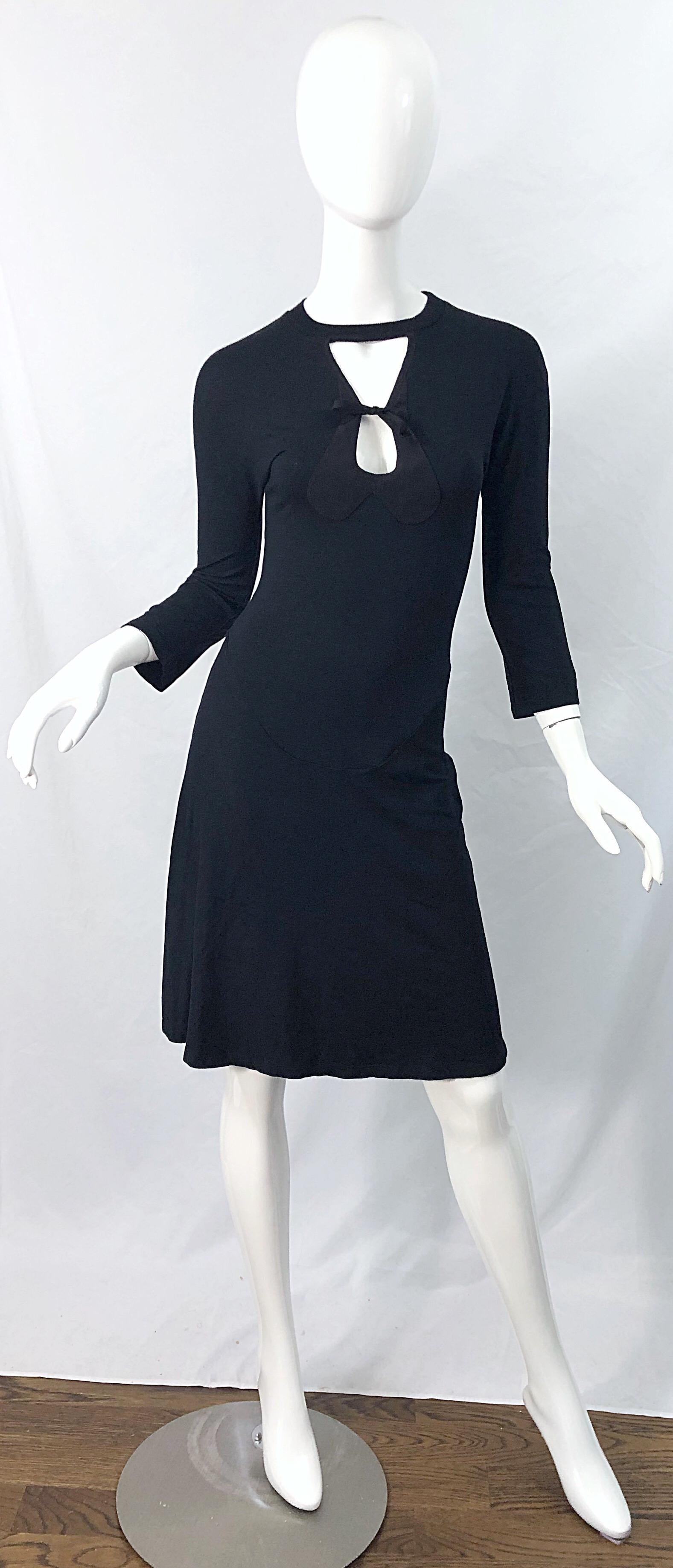 Sexy early 2000s GIBO black cut-out 3/4 sleeves dress ! Features cut-out above the bust that ties at the center. Simply slips over the head and stretches to fit. The perfect little black dress with so much attention to details. Soft Rayon (80%),