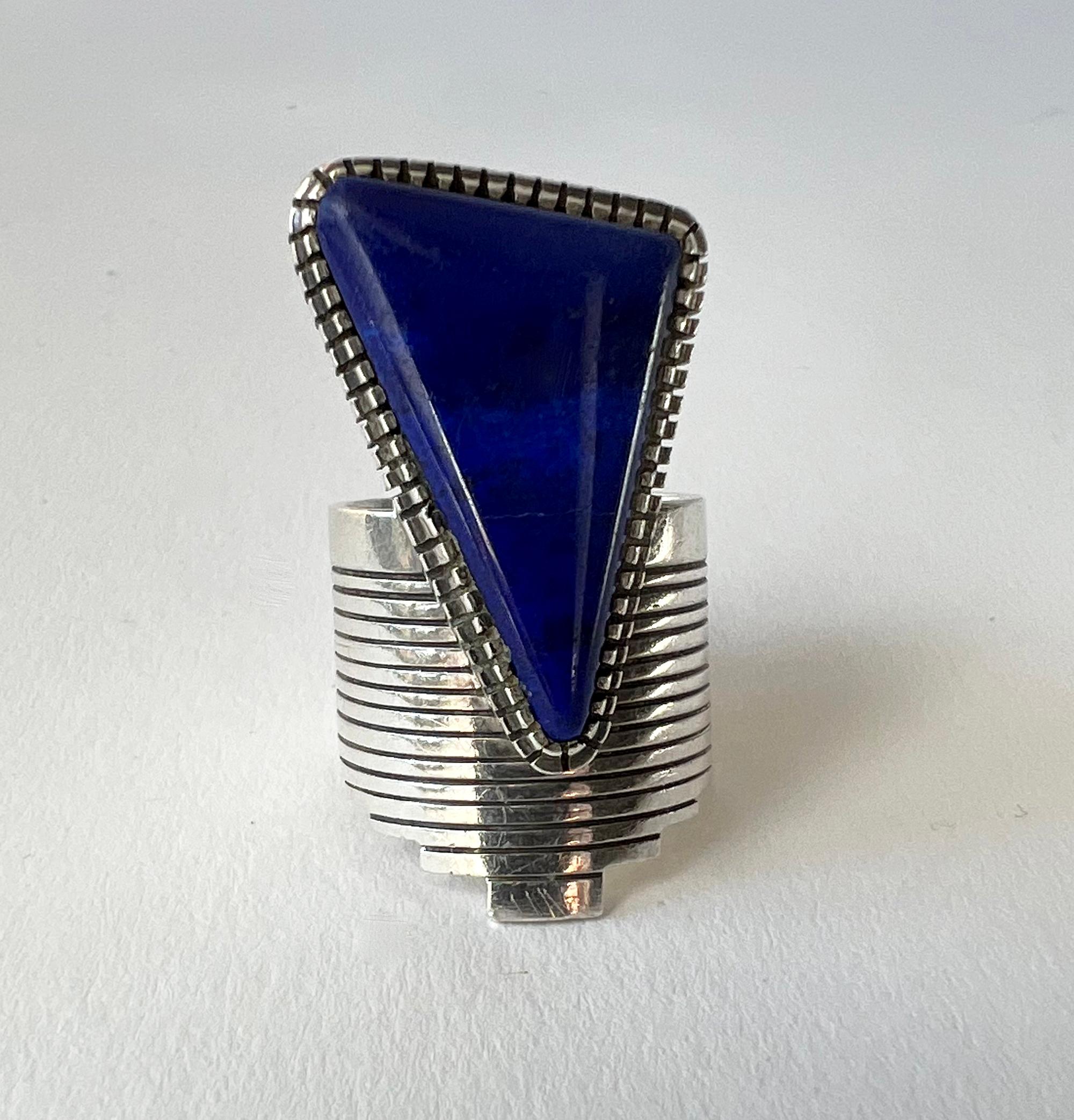 Large scale sterling silver and lapis lazuli ring created by Gibson Nez of New Mexico.  Ring is a finger size 8.75, but because of the width of the shank it will fit a bit smaller.  It is signed with the artists hallmark of GZN and in very good