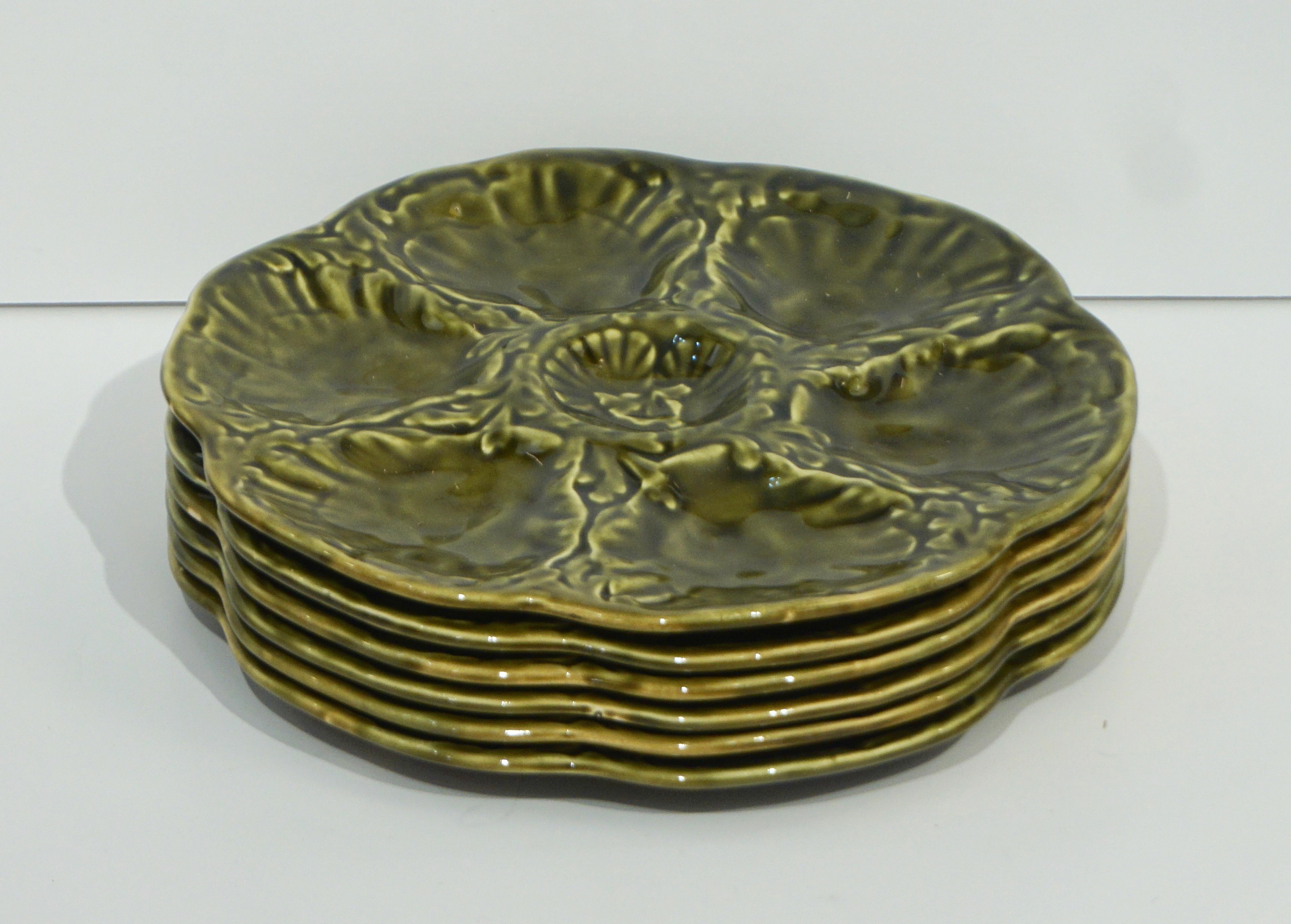 A Mid-Century Modern set of six French Faience oyster plates, circa 1950-1960, signed Gien in glazed barbotine ceramic with textured earth tones of moss green, this set is very special because still in its original organic modern wooden box,