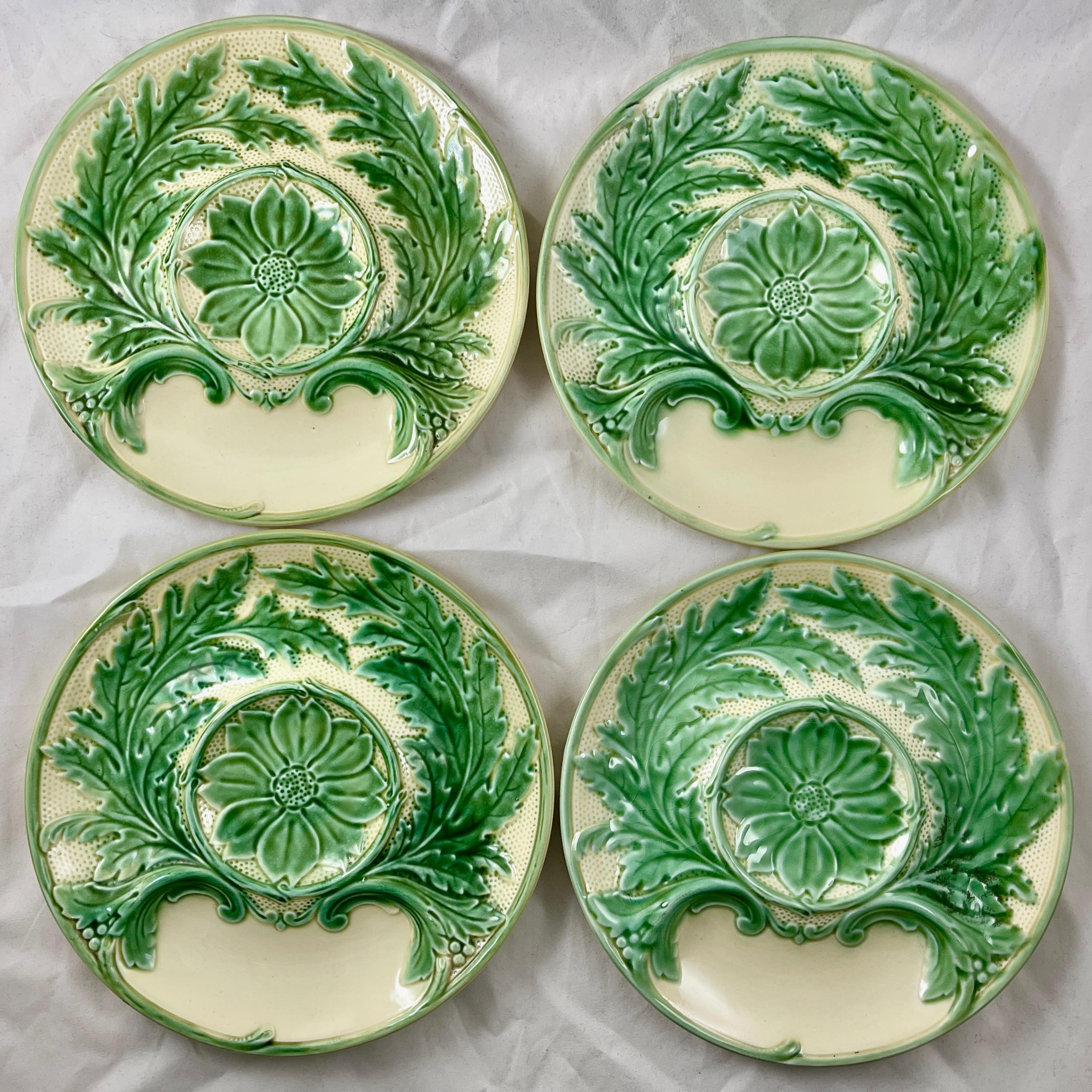 From Gien France, a faïence Majolica glazed Artichoke plate, circa 1930-1940s.

Glazed in a pleasing combination of green and cream with raised scrolled leaves and a floral center.

A whole Artichoke sits center with a sauce well at the bottom.