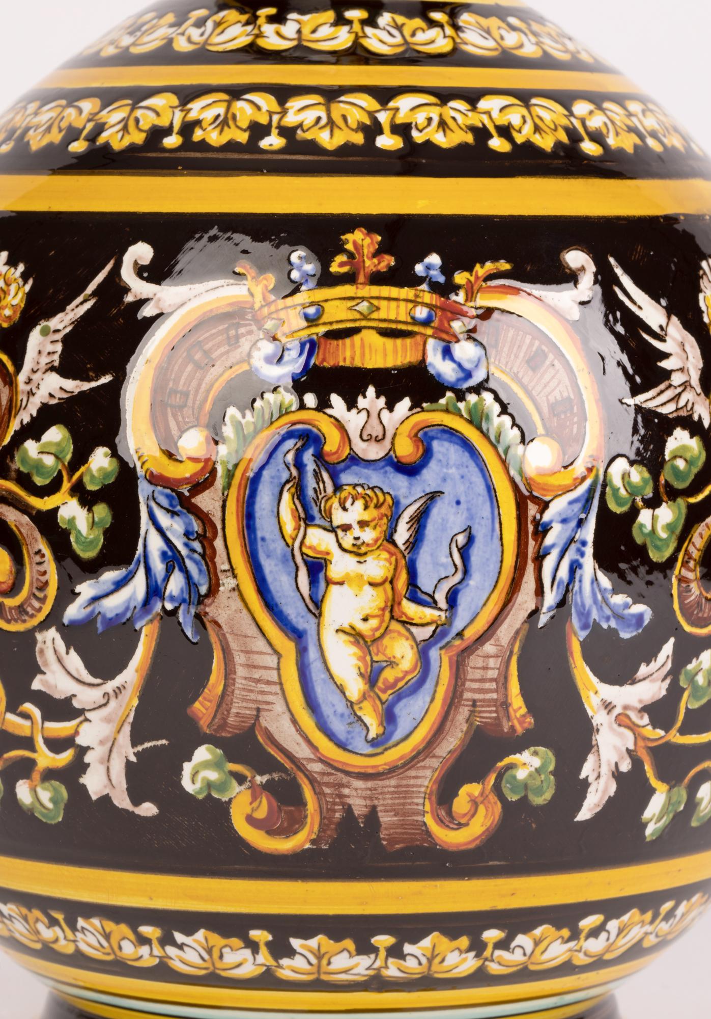 An exceptional and decorative French majolica art pottery jug decorated with neo-classical figural designs made by Gien and dating from around 1880. The jug stands on a narrow round pedestal foot and is of large round bulbous shape with a narrow