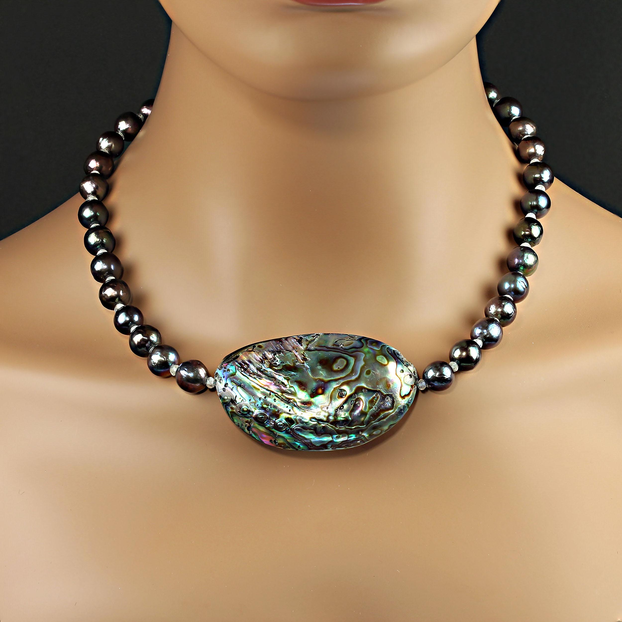 Gift from the Sea Necklace of Multi color Paua Shell focal and dyed 10mm Pearls with blue, green, and purple iridescence. The Paua Shell measures 61x37mm. Faceted Moonstone accents enhance the Pearls and Paua Shell. The necklace is secured with a