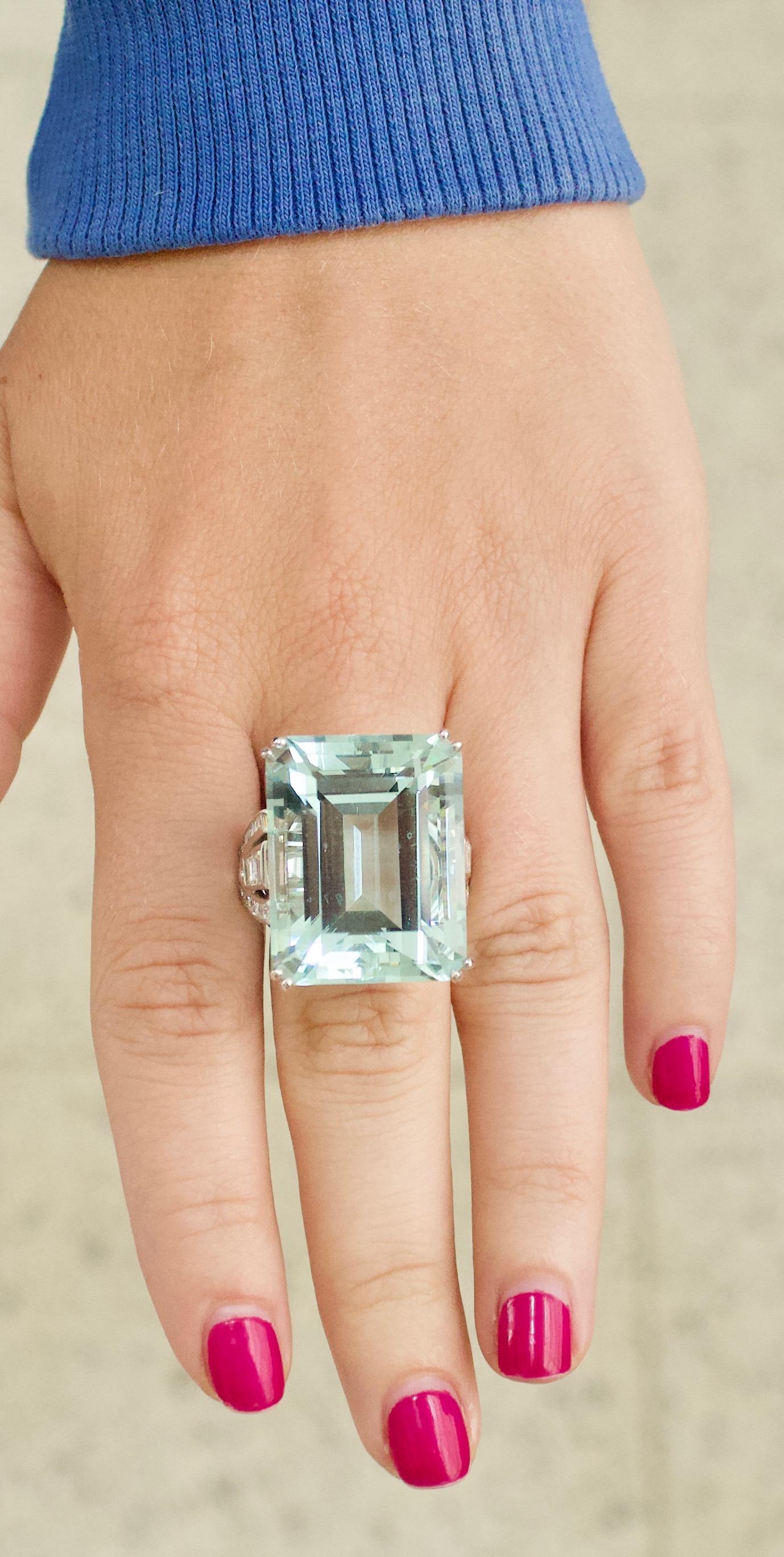 Gigantic 56.65 carat Aquamarine and Diamond  Ring in White Gold
Emerald Cut  Aquamarine weighing 56.65 carats [bright with no imperfections visible to the naked eye]
Eight Baguuettet Cut Diamonds weighing 1.00 carats approximately
Sixteen Square Cut