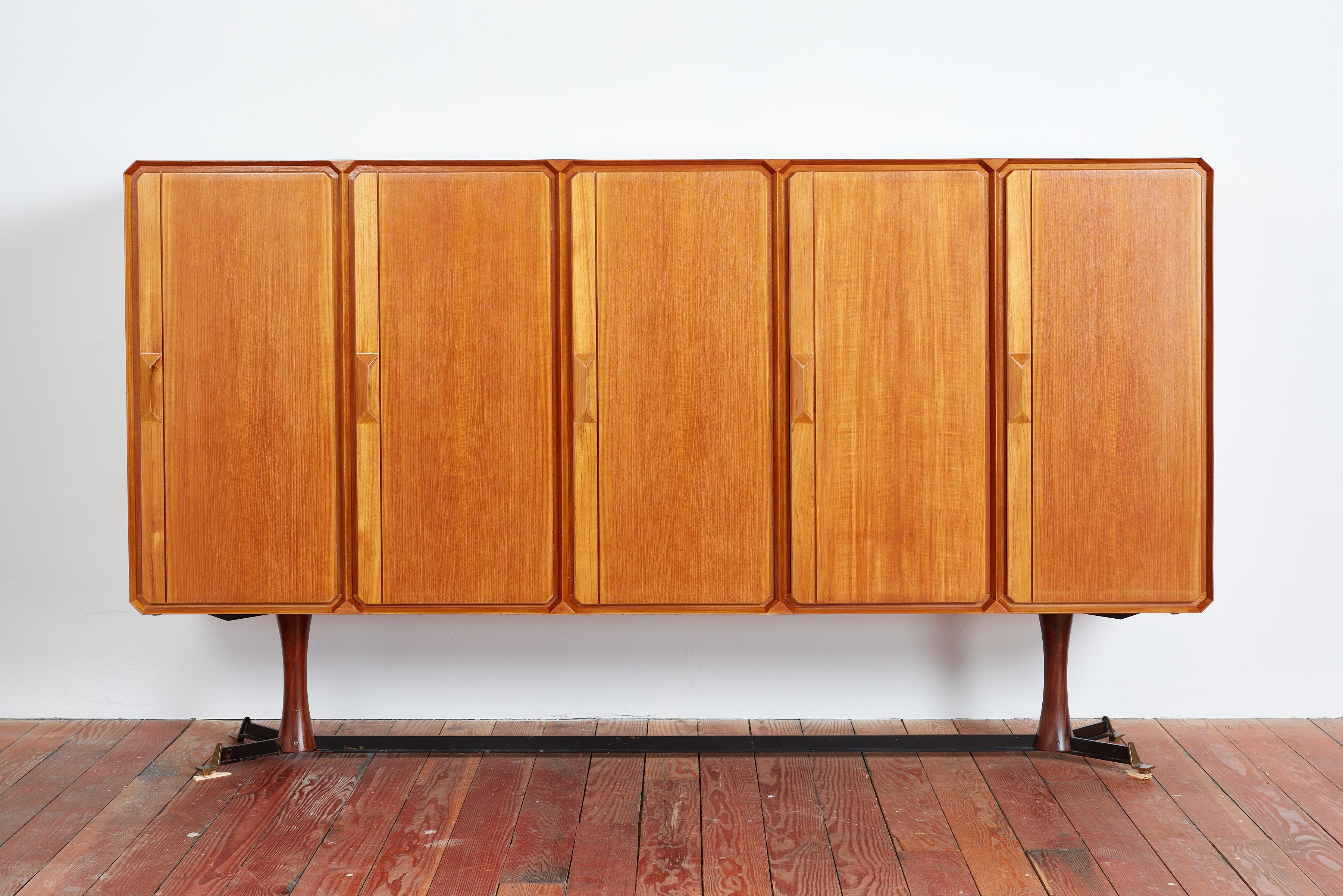Gigantic sideboard manufactured by Galleria Mobili d'Arte in Cantù, Italy, during the 1950s.
Constructed of teak wood, metal with brass - 
Original label 
All 5 doors open to reveal open shelving and drawers in center cabinet 
Suspended on wood
