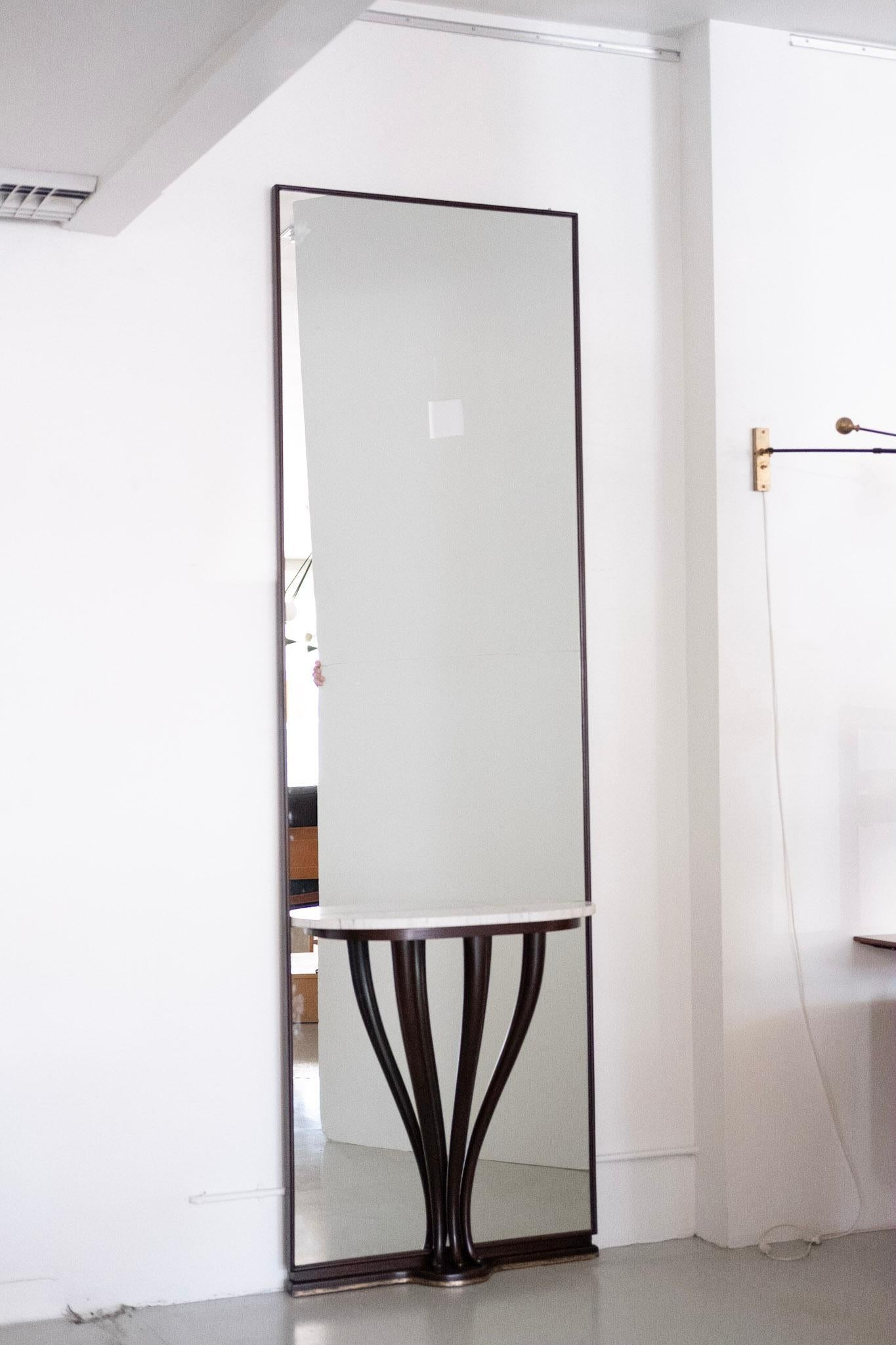 Stunning oversized floor mirror attributed to Fontana Arte.
Sculptural mahogany legs with Carrara marble tabletop and base has brass inlay.
Unique and impressive in size and scale.