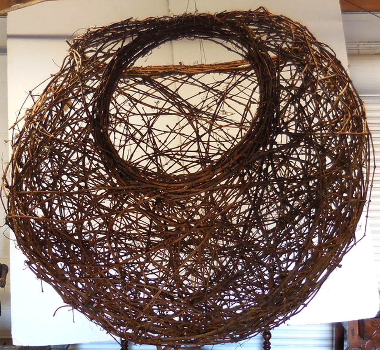 This basket like piece of woven grapevine can go inside or outside, on the ground or hung. Organic shape and materials. Great presence! Sphere with two openings. Would also look great as a large scale pendant light! Made by artist Matthew Culbert.