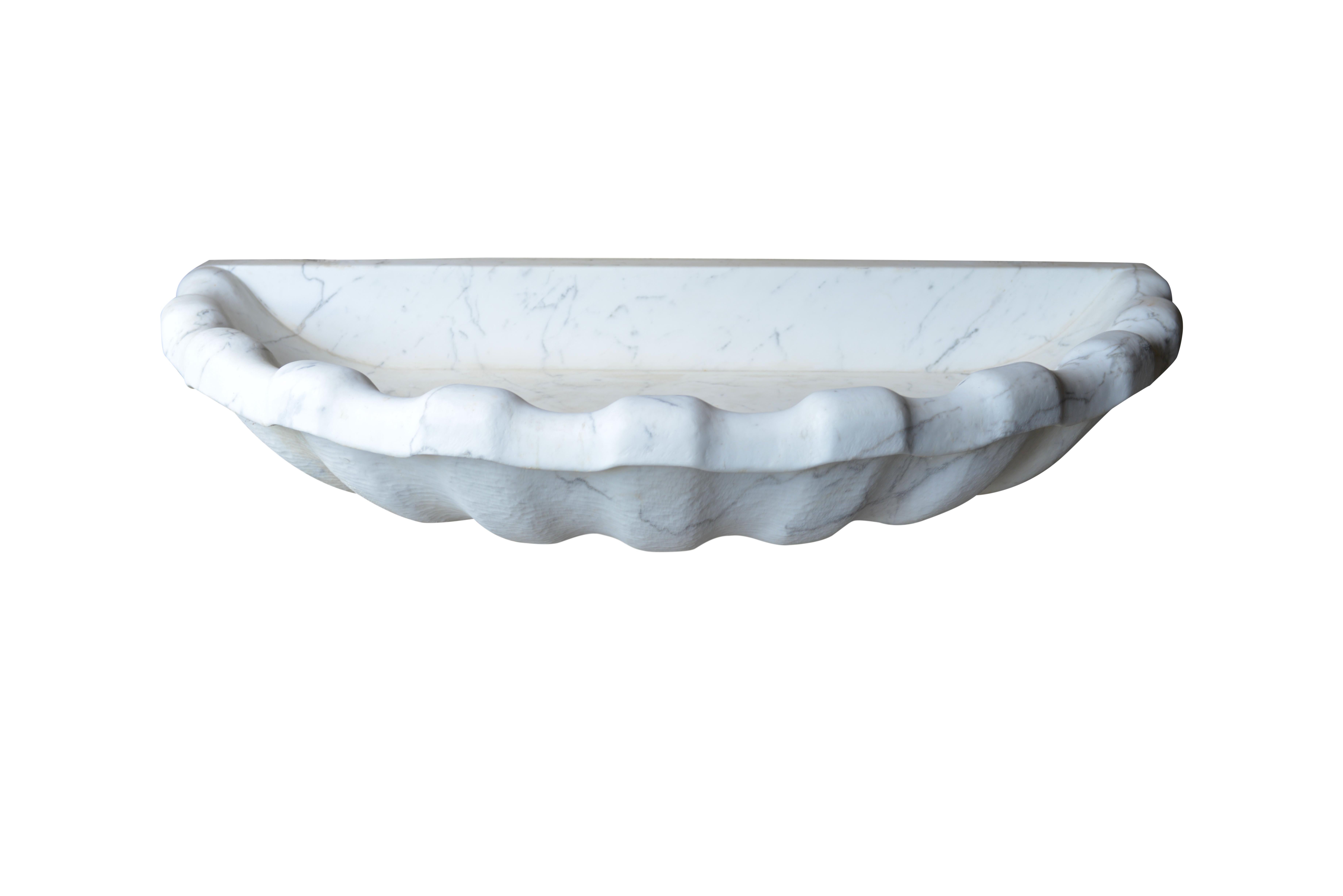 Magnificent over the top and out of proportion hand carved white Carrara marble classical style shell sink or shell cascading fountain. Carrara is a white marble quarried in the city of Carrara located in the province of Massa and Carrara in the