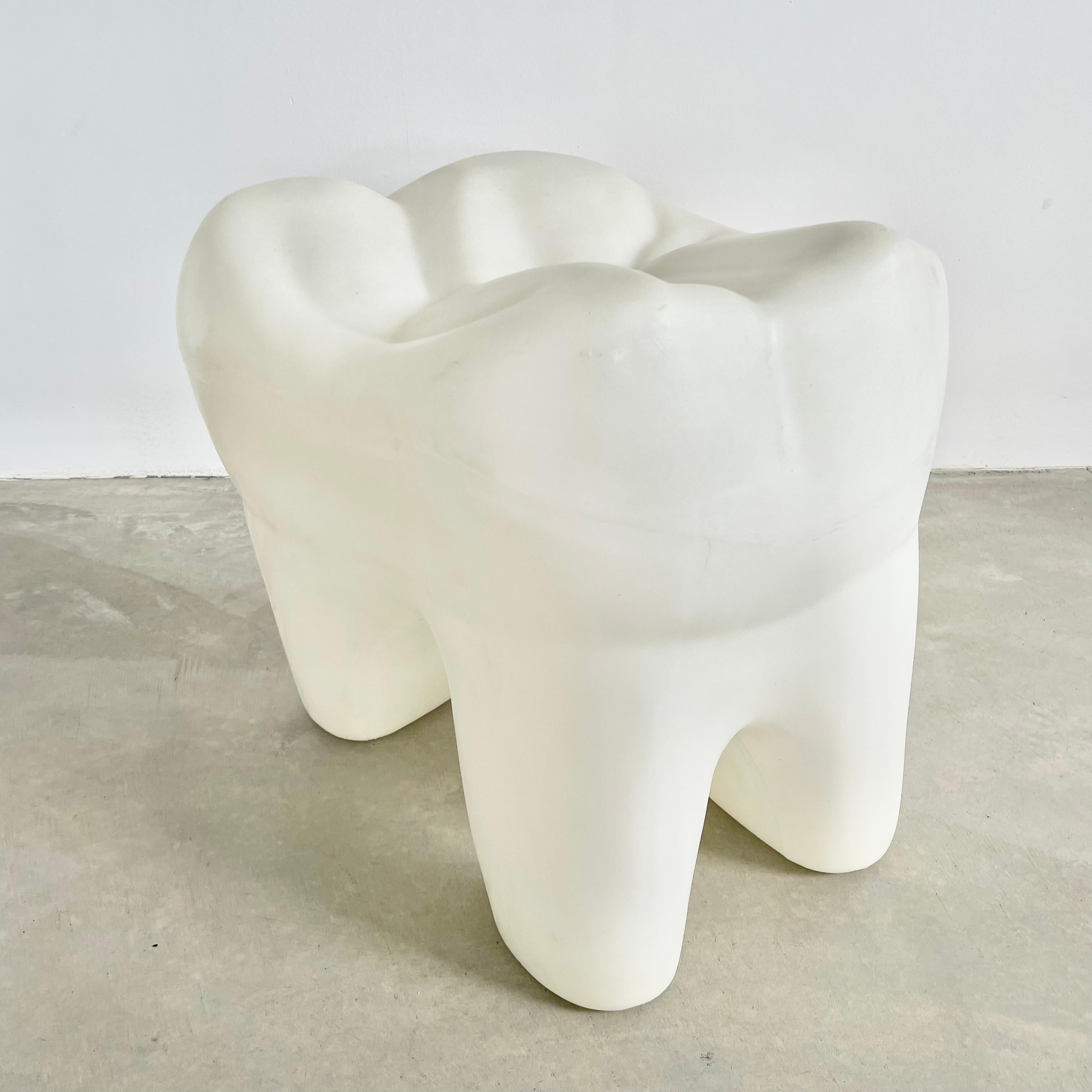 Incredible 3 legged molar stool made in Garden Grove, California. Substantial and tough plastic body held up by three sturdy legs made to resemble a tooth's roots. The seat of the stool has great tooth details as well including the pits and fissures
